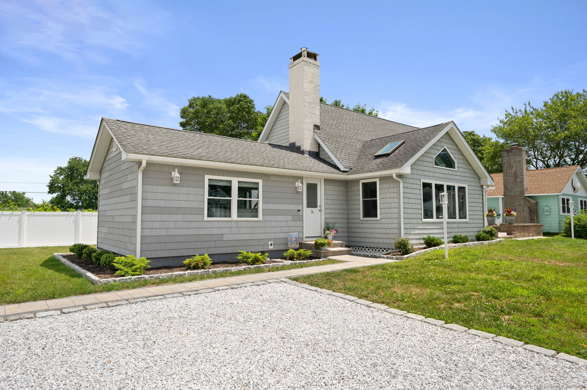 This completely remodeled & updated contemporary craftsman ranch style home is located just steps to the private association beach with LI Sound views from the property! The home features an open & airy concept that brings in the ambient light with plenty of dining and entertaining space both inside & out. The entire home has been tastefully & completely remodeled to include the open kitchen with center island & quartz countertops that flows seamlessly to the dining area, with it's gas fireplace, skylights & slider that walks-out to a new & beautiful paver front patio. The living room is also open to the kitchen & offers plenty of oversized windows as well as access to a spacious & new paver rear patio partially covered by a fixed awning ideal for Al fresco dining & entertaining many guests! Adjacent to the patio is an exterior full bath for outdoor entertaining as well as your return from the beach! There are also two bedrooms & a full bath with laundry on the main living level. The upper level features an exceptional primary bedroom & a 4th bedroom/office which offers a walk-in closet. A full bath rounds out this level. The home is situated on an oversized lot offering nice yard space & two driveways for plenty of guest parking. Additional features & amenities include new Luxury vinyl flooring & recessed lighting throughout the home, a storage shed & much, much more. You have to see this impeccable home & it's proximity to one of CT's premier private beaches to believe it!