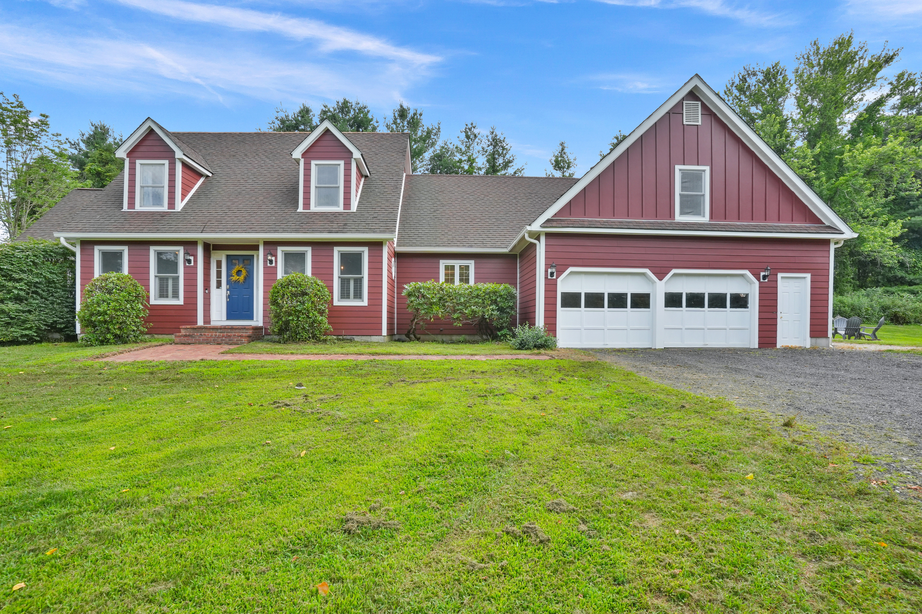 You'll love the versatile floorplan in this cape style home with a farmhouse feel!  Tucked on 2.45 pretty acres and surrounded on 2 sides by a tree farm, it affords peacefulness and privacy.  Step into the foyer and be amazed by the sunlight and spaciousness.  The main level features an office, formal dining room and living room with built-ins and fireplace.  The cheerful kitchen has painted cabinetry with new appliances, a peninsula with bar sink and breakfast nook. In addition, there is a powder room, laundry room and spacious mudroom adjacent to the oversized 2 car garage.  Looking for a main floor primary suite?  This one has french doors to the backyard, ample closet space, and the bath has double sinks, jetted tub and stall shower.  The upper level has an incredible amount of space with 3 bedrooms, 2 full baths, a playroom, exercise room and tremendous storage.  Whether using as a full time or part time residence, you'll enjoy the serenity of the land. Room for chickens, gardening and just relaxing.  Convenient location to restaurants, shops, hiking and local farms.