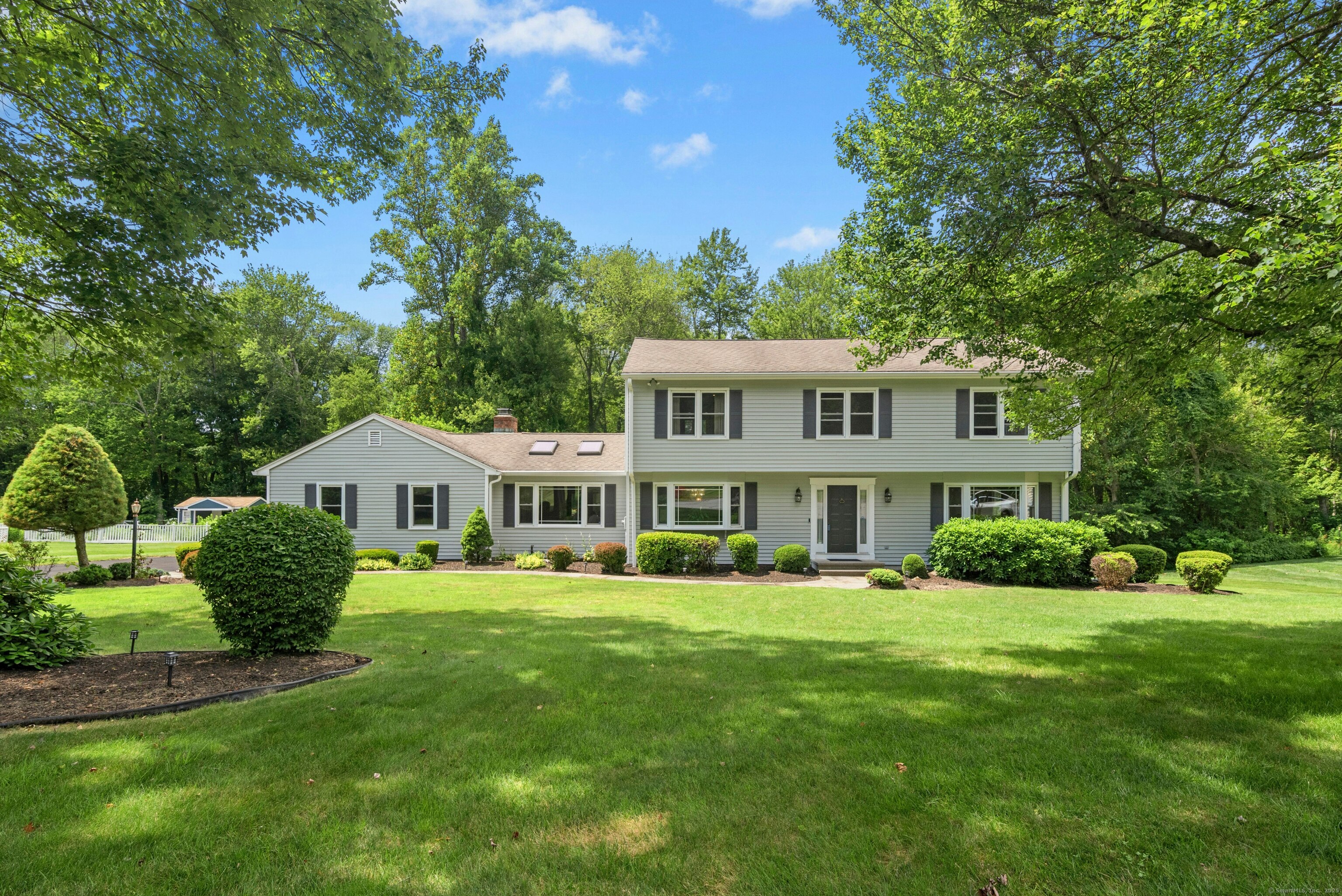 LOCATION, LOCATION, LOCATION! Introducing your DREAM HOME at 33 Shawnee Lane! Tucked away on a quiet cul-de-sac in one of Monroe's most desirable neighborhoods, this stunning 4-bedroom, 3-bathroom home sits on a beautifully landscaped 1-acre lot. Enjoy the peace and privacy of suburban living while being just minutes from major routes including I-84, Route 15, Route 8, and Route 25-perfect for commuting and accessing all that Fairfield County has to offer. Step inside and be welcomed by gleaming hardwood floors, an inviting family room with a cozy fireplace, and a built-in Bose surround sound system-ideal for movie nights or entertaining. The formal dining room is perfect for hosting holidays and special occasions, while the updated eat-in kitchen features stainless steel appliances, granite countertops, and easy access to the expansive Trex deck, where you can relax or entertain overlooking your private backyard oasis. Upgrades abound, including central air conditioning with split systems for optimal cooling, smart thermostats, and an irrigation system to keep the lawn green and lush. A top-of-the-line Weil McLain boiler ensures year-round comfort and efficiency. You'll also appreciate main-level laundry, updated windows throughout, and a home security system for added peace of mind. Large unfinished basement provides ample space for storage. Located just minutes from Wolf Park and other local amenities, 33 Shawnee Lane is more than a house-it's a place to call home.