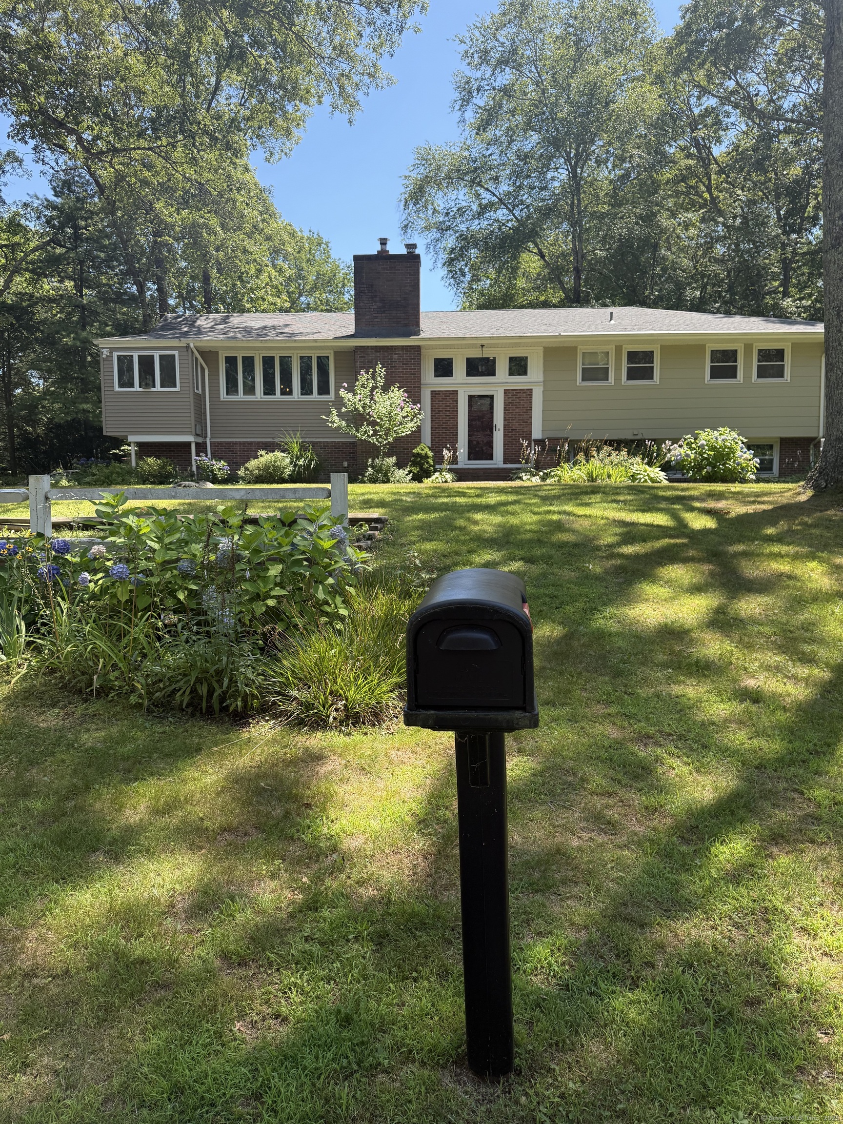 In one of the most established neighborhoods of Niantic sits this expansive 4-5 bedroom, 3 full bathroom Garden Ranch home with over 3000 square foot of living space. Walk in the front door and up the hardwood stairs. In front of you on the outter wall is windows from floor to cieling overlooking the Koi pond, water fall, fire pit and enormous brick padio for entertaining & grilling.To your left is the living room featuring hardwood floors and a real fireplace and woodstove for those cold winter nights. At the end of the living room theres Lots of natural light with the cathedral cieling & windows, Go into the open dineing room with plenty of room for large family seatings. Then theres the luxurious chefs kitchen with cherry cabinets, beautiful granite counter tops, pull out shelves a built in hutch and breakfast bar. This home features the primary bedroom suite on the main floor with 2 other bedrooms located on this floor all with hardwood floors and cieling fan, Theres tile in the main bath off the hall and tile in the primary suite bath. Go to the lower level and theres a new vinyl plank floor throughout except in the baths that is tile..The lower level has a great room for a play space or another living room, theres also a separate laundry and two more bedrooms. A New Generac House generator will never let you be without power for more than a few seconds. Schedule a showing before its too late.