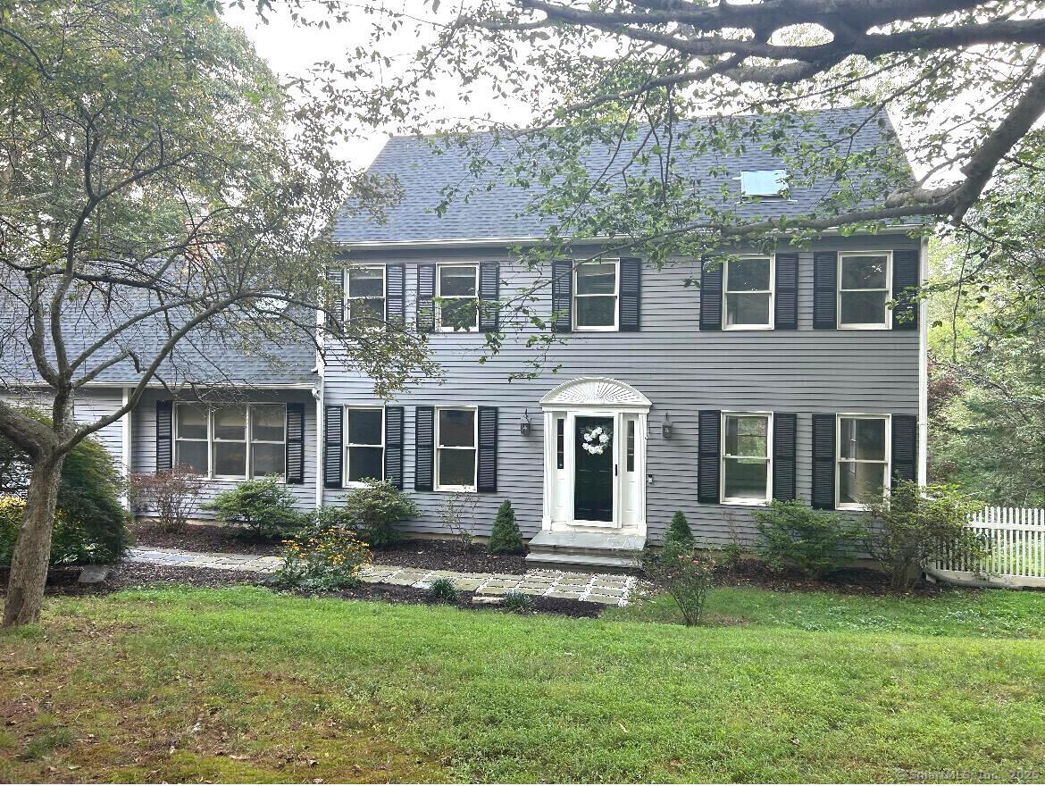 Beautifully updated Colonial-style home that blends timeless character with fresh, modern finishes. This home is a rare combination of space, style and location! Set on a spacious 0.68-acre lot, this is one of the largest lots in this sought-after neighborhood that is just minutes away from both 1-95 and popular Stony Creek Beach. This home welcomes you with gleaming hardwood floors throughout and a beautifully remodeled kitchen with quartz countertops and stainless steel appliances. The kitchen leads into a formal dining room and spacious family room with abundant natural light, Cathedral ceilings, skylights and fireplace. In addition, a cozy living room is located on the opposite side of the kitchen, perfect for hosting family and guests. Upstairs, the primary bedroom is complete with vaulted ceilings, large closets and an updated en-suite bath. In addition, you will find three additional bedrooms and a full hallway bath. The fully furnished lower level is truly something to enjoy and offers an impressive nearly 900 sq ft. of additional living and entertaining space, including new vinyl flooring throughout and an additional full bath. Step outside from the kitchen onto the spacious deck and enjoy the peaceful, tree-lined backyard. Additional features include an attached 2-car garage, main-level laundry, newer roof, brand new furnace and septic system and turnkey updates throughout. Don't miss your chance to own this special property in a wonderful location! Agent/Owner.
