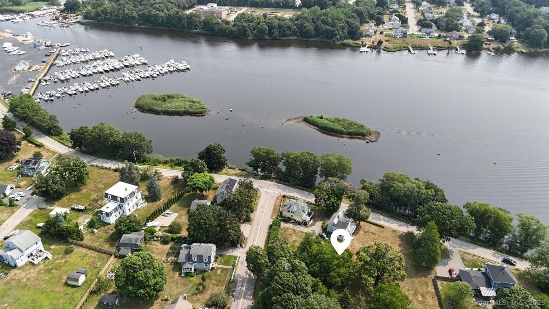 Enjoy awesome water views in this antique home out of the flood zone with a non buildable lot across the street from to paddle board , Kayak and potential for building a dock or having a mooring on Pawcatuck River with direct access to Watch Hill, Sandy Point and open Ocean. Minutes from downtown Westerly, Wilcox Park. Live performances in Granite theater. Stonington Borough , beautiful Misquamicut beaches and so much more. Remodel existing home to your liking and add an accessory building for visitors or build your dream home on the spacious level lot.