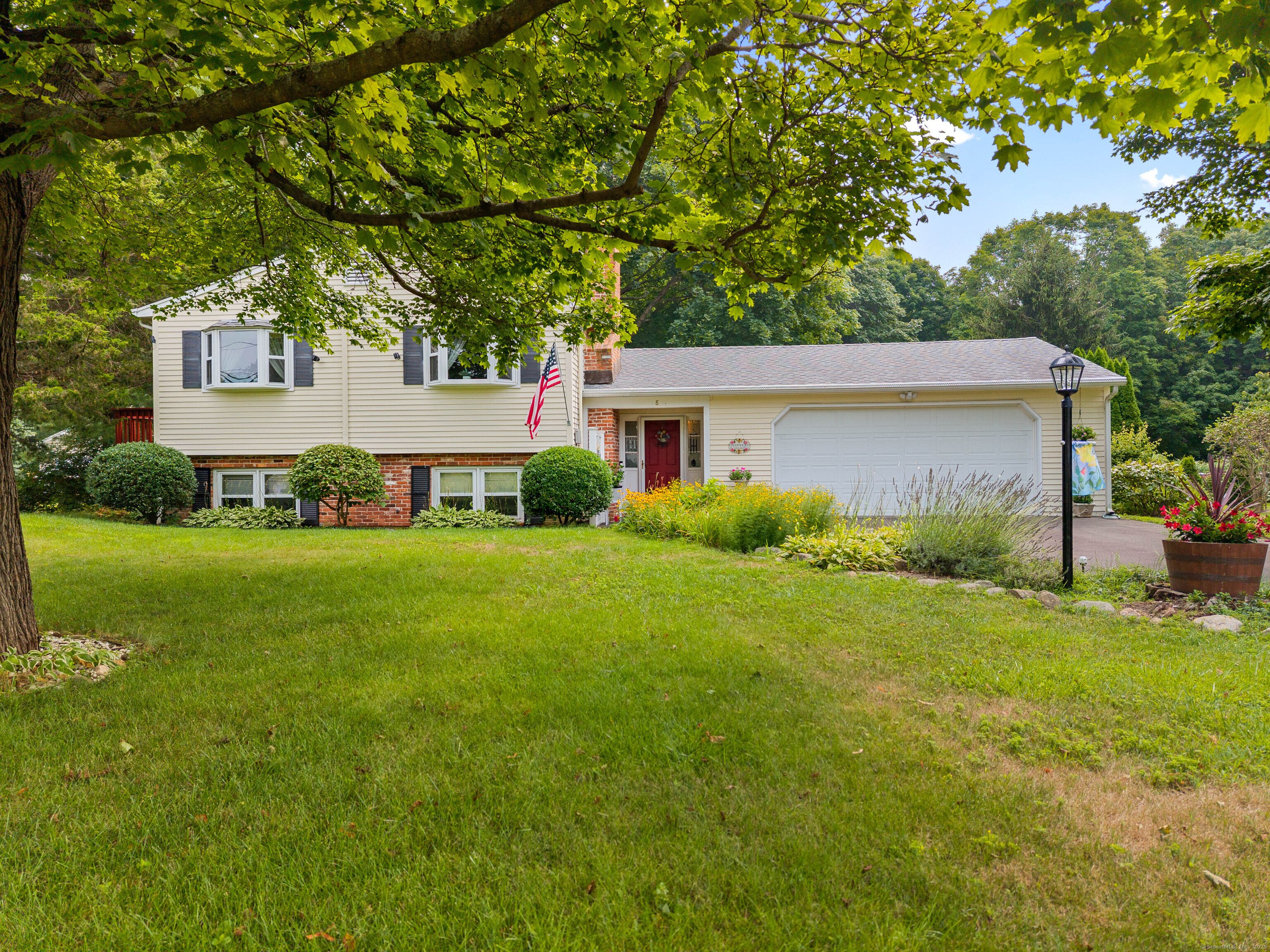 Welcome to 8 Horseshoe Road, Guilford  Set on beautifully landscaped grounds, this well-maintained split-level home offers a blend of comfort, character, and functionality. Featuring 2 Fireplaces, 3 bedrooms and 2.5 bathrooms, the upper level showcases wide-plank wood flooring that adds warmth throughout the main living areas.  Mini-split systems provide efficient heating and cooling for year-round comfort. A spacious two-car garage offers plenty of room for parking and storage. Enjoy outdoor living with a small deck off the kitchen and a larger backyard deck complete with an awning-perfect for relaxing or entertaining. The expansive backyard provides a private setting surrounded by mature landscaping.  This inviting property is located in the desirable Sunrise Community and is ready for its next chapter. Schedule your private showing today.