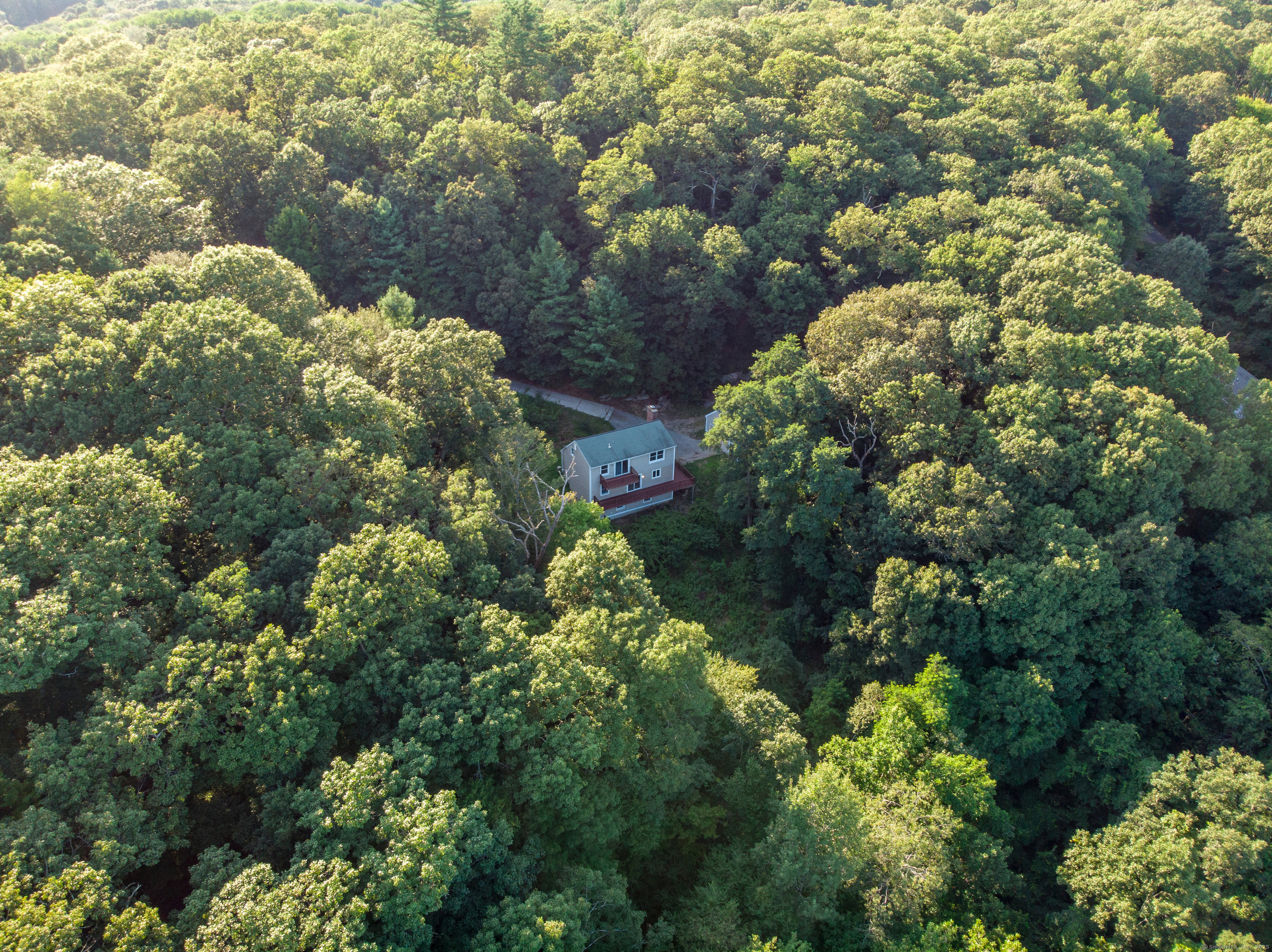 Step over the RI and Mass line and check out this Cape on 6.55 ACRES great for dirt bikes, 4 wheelers or animals! HEATED Garage to spend the Winter evenings. BEAUTIFUL NEW white shaker cabinets and GORGEOUS GRANITE counters w/ STAINLESS appliances open to dining area with slider to WRAP AROUND DECK that has a view of the valley. FIREPLACE living room and 1 st floor bedroom next to large bathroom w/ double vanity NEW GRANITE counter, jetted soaking tub and stand up shower. NEW CARPET on stairs and bedrooms. One has DOUBLE closets for storage the PRIMARY has a balcony for your morning coffee, large closet and bathroom w/ shower and vanity with GRANITE. WALKOUT basement has alot of space you can finish w/ DOUBLE OIL TANKS ,updated electrical, boiler and hot water heater. Driveway is steep but great for Jeeps, Broncos, Trucks or anything 4 wheel drive also has plenty of parking at the top for multiple vehicles. Many possibilities with the sloping land so bring your backhoe and tractor! Fall view is beautiful when the leaves are changing. Close to RI, Mass and Rte 6.