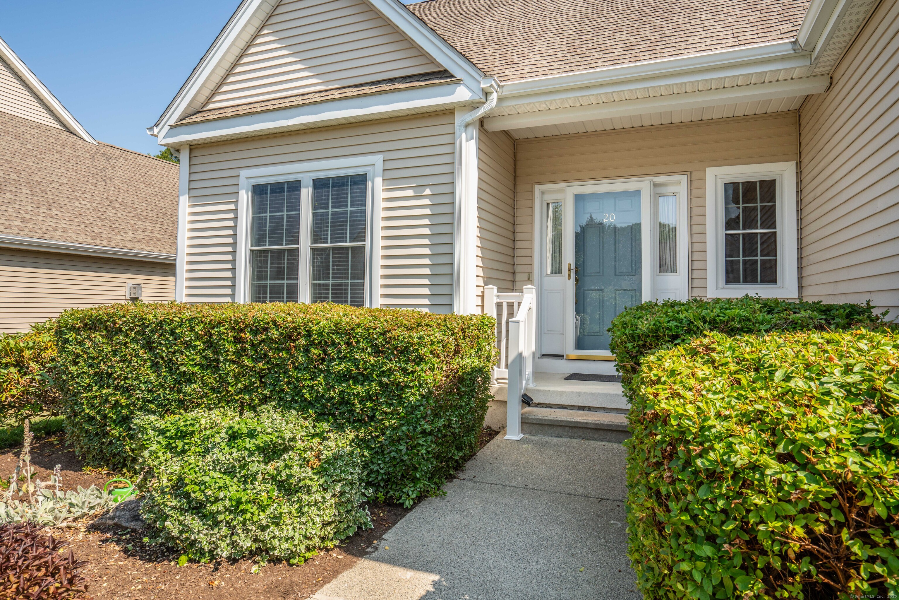 Welcome to 20 Spinnaker Drive-an elegant and spacious Plymouth Model home in the highly desirable 55+ Spinnaker community of Niantic. This 3-bedroom, 2.5-bath freestanding Cape-style condominium offers the comfort of single-family living with the convenience of low-maintenance condo ownership. With over 2,170 square feet of well-designed living space, the main level features a sun-filled great room with vaulted ceilings and a cozy gas fireplace, a formal dining room with hardwood floors, and an open-concept eat-in kitchen complete with Corian countertops, a breakfast bar, and sliders to a private deck-perfect for morning coffee or evening gatherings. The main-level primary suite includes a walk-in closet and ensuite bath, allowing for easy one-floor living if desired. Upstairs, you'll find two generously sized bedrooms, a full bath, a large office or den, and three easily accessible walk-in attic storage areas. Additional highlights include central air, a two-car attached garage, a full basement with interior and hatchway access, and an on-demand Generac propane generator for peace of mind. Located just minutes from Niantic's beaches, shops, and dining, this home offers a serene coastal lifestyle with convenient access to major routes. Schedule your private showing today and experience the best of East Lyme's active adult living!