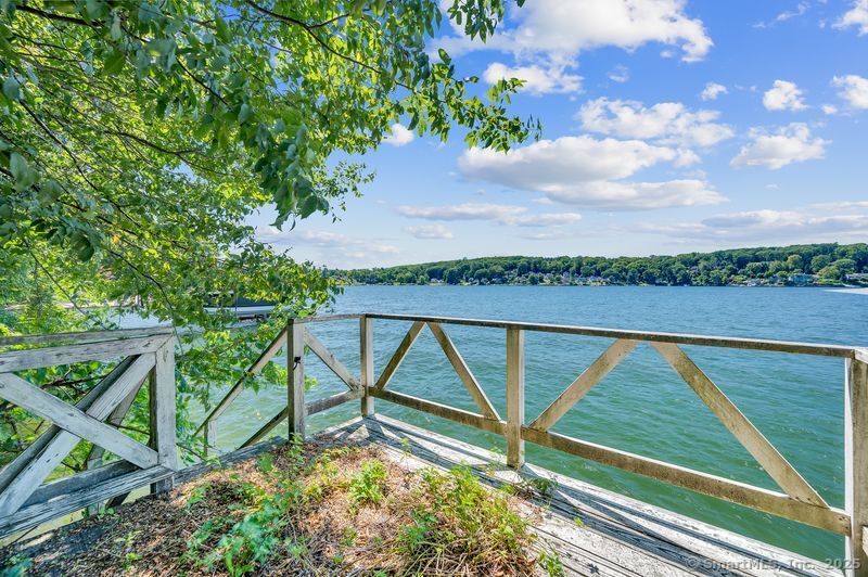 Beautiful direct waterfront property on Candlewood Lake! Lovely lot spanning over 1/2 acre with elevation to provide expansive lake views. Stone terrace and meandering stairs to dock. The house will shine with some TLC! Small outbuilding as well. Tons of potential. All contracts to be subject to probate court approval. Property to be sold "as-is". All due diligence to be performed by perspective buyers. This is an estate.