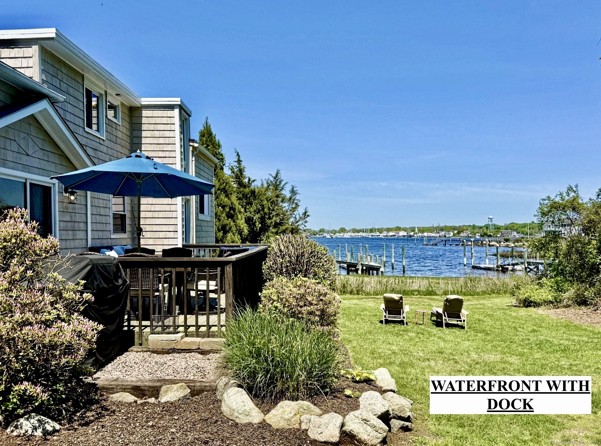 WATERFRONT ON THE MYSTIC RIVER - Not a "Drive BY" This lovely home must be seen on the inside and from the backyard and deck in order to get the full picture! A YEAR ROUND RETREAT WITH SUMMER WRITTEN ALL OVER IT ! Welcome to "On The Mystic" - A thoughtfully remodeled and fully furnished waterfront home nestled on the serene shores of the Mystic River. Located on beautiful Mason's Island, this property offers a rare blend of spectacular water views, tranquility and privacy yet it is only minutes from historic downtown Mystic. While summer may steal the spotlight, On The Mystic offers a unique charm for each season. Paddle or cruise from your 1/3 shared dock to nearby Mystic or embark upon adventures to the Long Island Sound and the endless boating destinations beyond.  Inside this fully furnished and accessorized home you will enjoy a bright and open floor plan with seamless flow between the kitchen, dining area and living room. Each of the three bedrooms offers privacy as well as its own en-suite full bath. A separate family room adds flexibility for a home office, movie room, quiet retreat or great play area. Step outside to the generous riverside deck, with comfortable lounge seating and a large dining area,- Ideal for summer bbqs on the water, or cozy up in the adirondack chairs by the firepit while watching the last rays of sun settle over the river. Whether you are looking for a peaceful full-time residence or a weekend/summer escape, this home truly has it all!