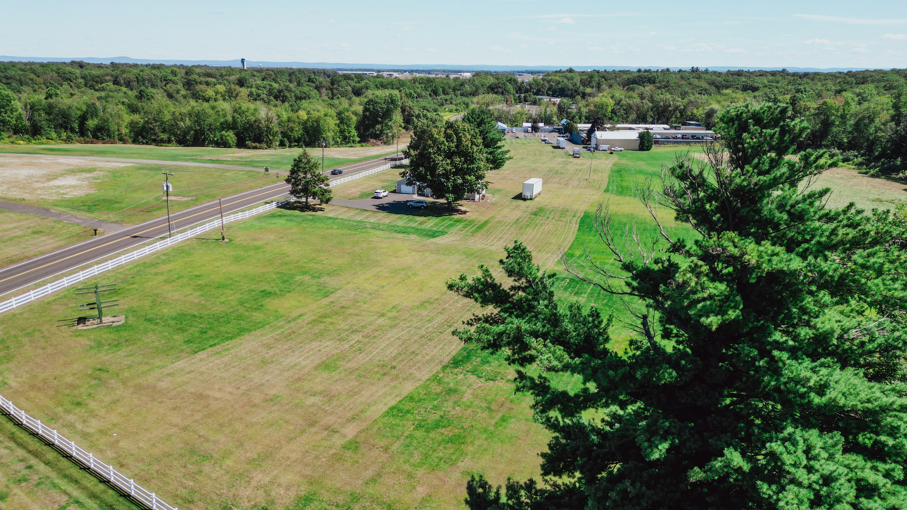 Private FAA heliport CT-50. Combination of three parcels totaling 11.44Acres in the CPT Commerce Park Transition Zone. Approx 900ft of frontage on East and Russell Rd. Property is surveyed, flagged, and shovel ready under full approval for a 40,000sqft warehouse/trucking terminal. Many permitted uses including Medical, R&D, Labs, Light Manufacturing, Warehouse and Distribution, Retail, Indoor storage, Indoor recreation. Special uses include Assisted Living, Hotel, Multi family residential, Etc.  Single family house in move in condition on the property with an attached one car garage, full basement, metal roof, and central air. 60x55ft hangar building. Close proximity to BDL, RT. 20, and I91. Right between Hartford and Springfield. Close proximity to Amazon Distribution center, Walgreens distribution, Bradley Tradeport, etc. East Granby is in the midst of an economic Renaissance and this is the perfect location for your business or vision.