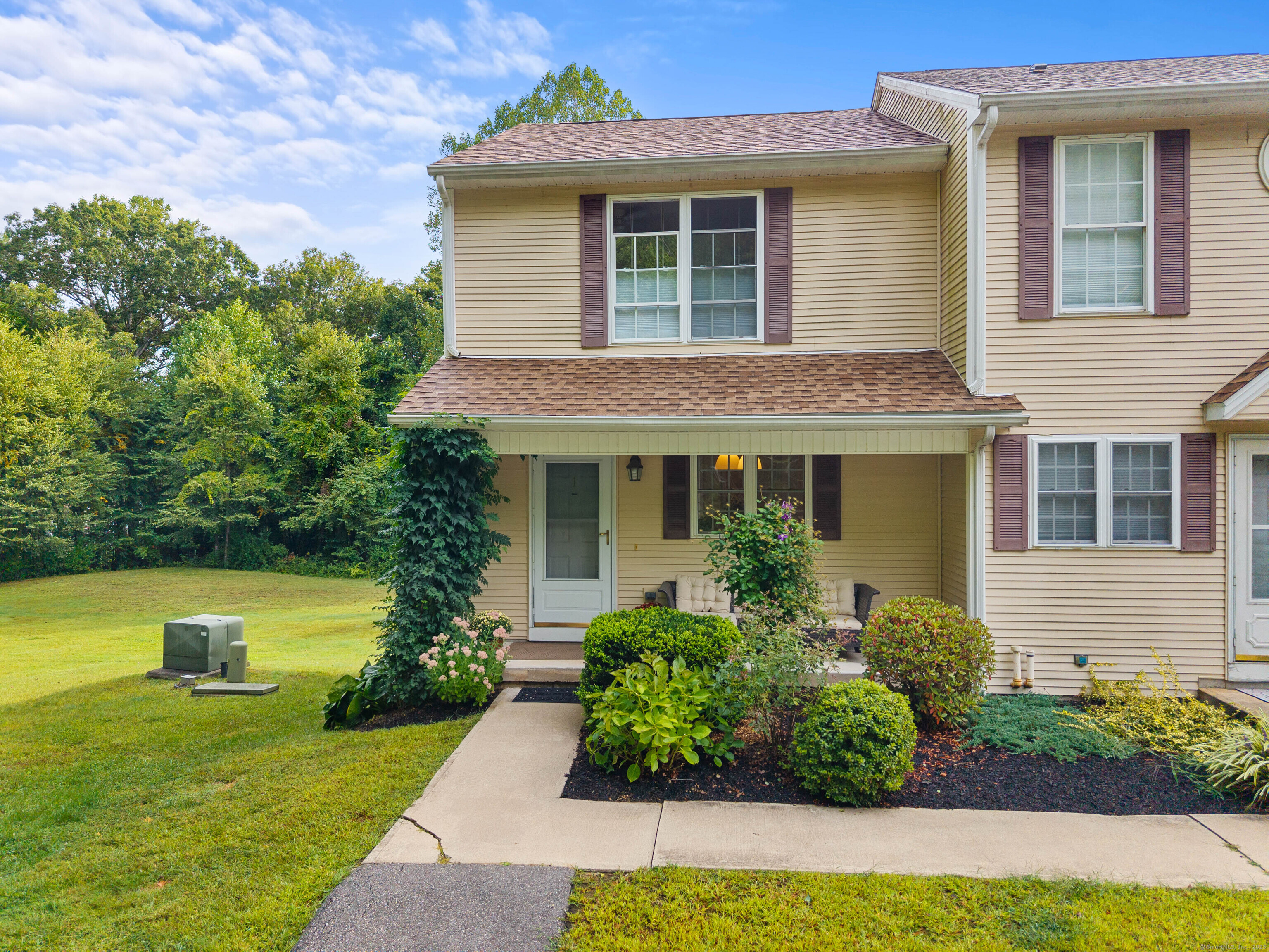 Experience the charm and privacy of this end-unit Townhouse at Countryside Condominiums in Ledyard Center! This 2-bedroom, 1.5-bath condo is a two-level townhouse with an open floor plan designed for comfortable everyday living. The kitchen includes a small center island and flows nicely into a combined dining and living room area. On the upper level are two generous bedrooms, including a walk-in closet in the primary bedroom. The townhouse also offers a convenient walk-out full basement, perfect for extra storage or future customization. Step out onto your private deck and enjoy the peaceful surroundings, as the unit backs up to the woods, providing added privacy and a natural backdrop. Situated on a cul-de-sac, this home offers a calm setting just minutes from local conveniences. The town recently completed a new multi-use path, ideal for a morning or evening stroll. Explore nearby Colonel Ledyard Park, which features a pavilion, hiking trails, playground, baseball and soccer fields, tennis courts, and a volleyball court, all within easy reach for outdoor recreation. You are also close to Mohegan Sun and Foxwoods Casino, which includes the Tanger Outlets. Major employers such as Electric Boat, Pfizer, and the Naval Submarine Base are just a short drive away. Move-in ready and nicely located, this townhouse presents a wonderful opportunity to enjoy comfort, convenience, and community.