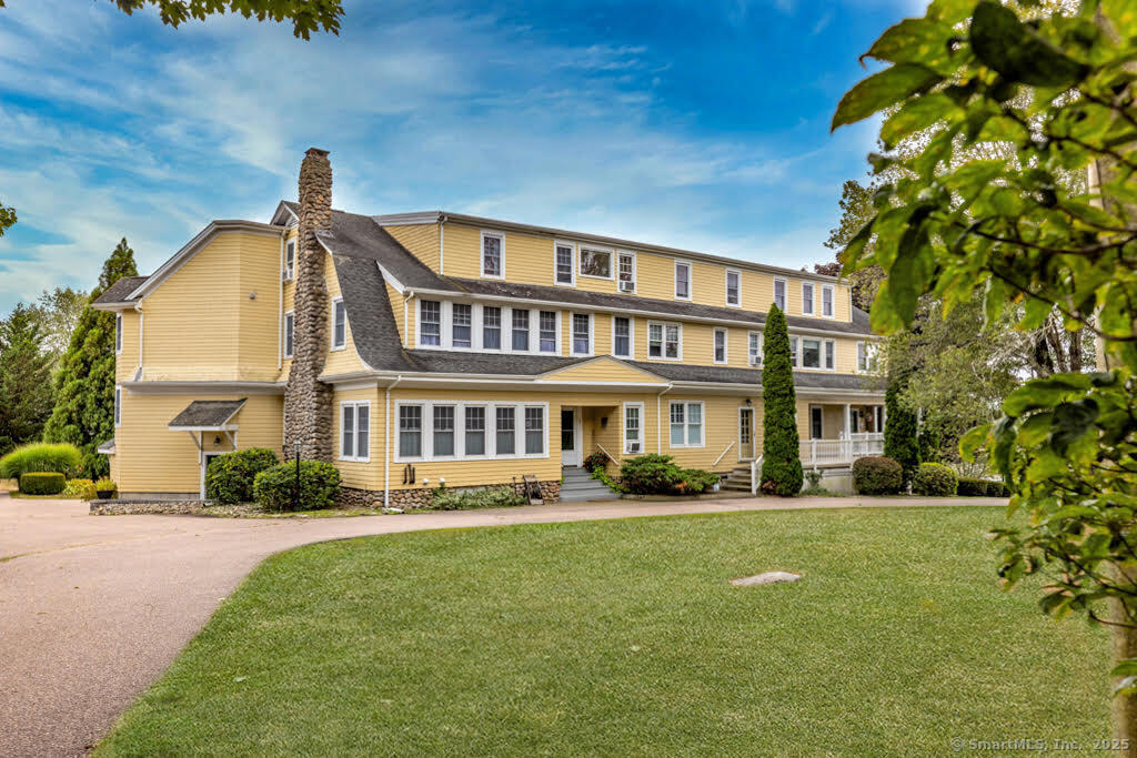 Discover upscale coastal living in one of the largest units within an exclusive 10-condo community in the sought-after Lords Point area. This meticulously maintained third-floor end unit offers privacy, comfort, and distant water views of Fisher's Island Sound. Enjoy the convenience of one-level living with a private entrance and sun-drenched balcony overlooking beautifully landscaped gardens and serene south-facing vistas. The spacious layout features two primary ensuite bedrooms, ideal for flexible living or hosting guests. The interior has been tastefully renovated, featuring fresh paint, new flooring throughout, and a beautifully updated kitchen with quartz countertops, new cabinetry, and stainless steel appliances. Both bathrooms have been stylishly modernized, and a full-sized washer and dryer are conveniently located in-unit. Situated between historic Stonington Borough and vibrant downtown Mystic, this home offers easy access to I-95 while maintaining a peaceful, coastal atmosphere.  Monthly HOA fees include heat, water, sewer, landscaping, snow removal, and 2 assigned parking spaces. There is an assigned basement storage space for added convenience. Don't miss this rare opportunity for elegant, low-maintenance living in one of Stonington's most desirable communities.