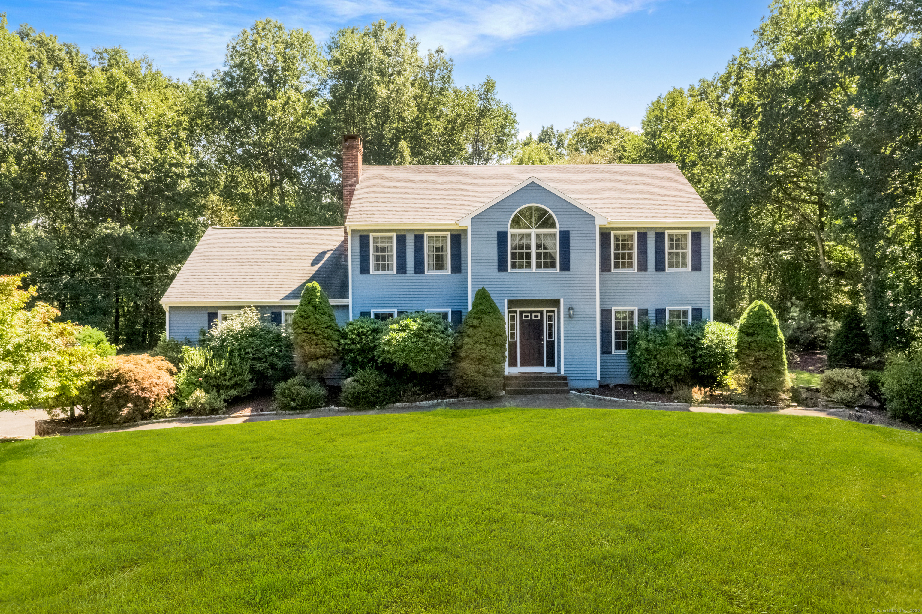 This custom-built Colonial offers 4 bedrooms and 4 bathrooms, nestled on 3 serene, private acres with stunning pond views. The spacious layout features a primary bedroom with an en-suite bathroom and walk-in closet, plus a potential 5th bedroom on the main level, conveniently located steps from a full bathroom. The expansive family/great room is perfect for relaxation equipped with a beautiful wood burning fireplace, while the large eat-in kitchen provides access to a deck ideal for outdoor entertaining. Formal living and dining rooms showcase elegant hardwood floors. The walkout lower level offers additional living space, including another family room, a home office, a full bathroom, and direct access to the three-car garage. With meticulously maintained grounds, this home embodies pride of ownership and offers the perfect private retreat for peace and tranquility.