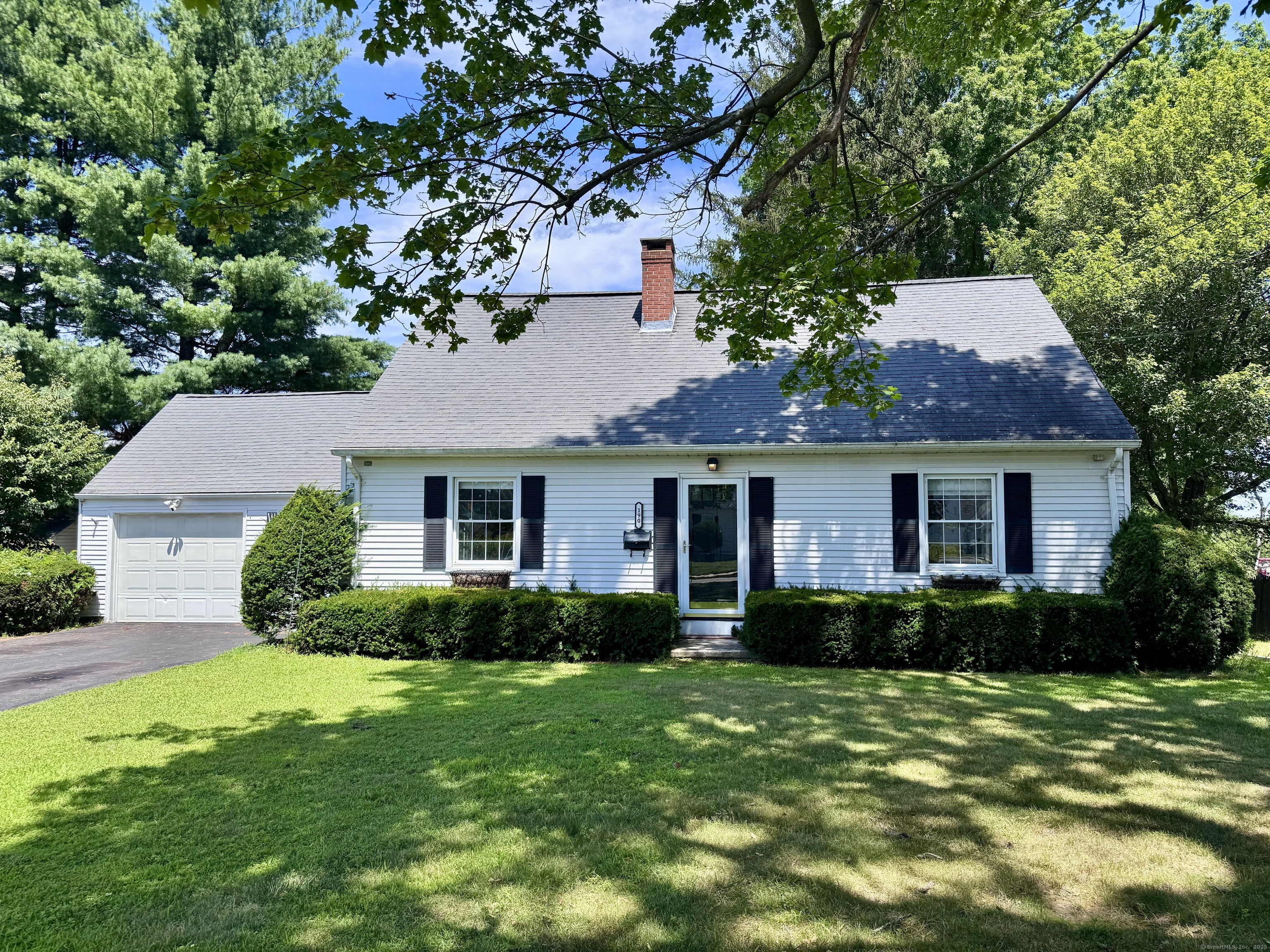 You won't want to miss this spacious 2,050 sq ft custom-built Cape, full of character and solid craftsmanship throughout including original woodwork, built ins, detailed moldings, and custom finishes.  Enter through the attached garage into a roomy breezeway with a wood-accented recessed ceiling with crown molding and craftsman wainscoting. Inside, the stunning living room is filled with natural light and features hardwood floors and a beautiful custom stone fireplace with a propane insert. The formal dining room offers another cozy brick fireplace and charming built-ins, just off the kitchen with white cabinets, a wood-paneled ceiling, and a breakfast bar.  The main level includes a full bath and two generous bedrooms-one with an accessible en-suite bath, private deck, and its own entrance-ideal for a possible in-law or guest suite.  Upstairs, you'll find two more spacious bedrooms and a third full bathroom, giving you plenty of flexible living space.  Out back, enjoy a private yard with a large deck, stone patio, and stone wall-perfect for relaxing or entertaining. There is also a fantastic storage shed, a power line has also been run to it from the house and outlets roughed in - ready for its own sub panel installation.  With great bones and tons of potential, this custom home is ready for your personal touch! A rare find in Windsor Locks.