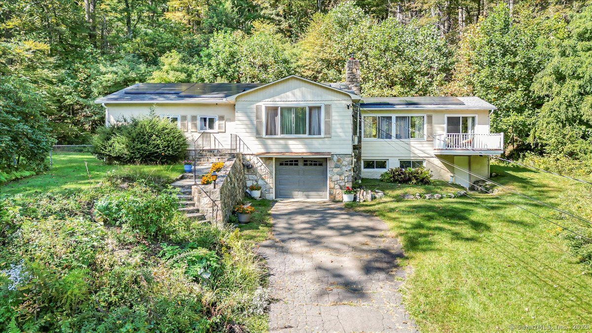 This beautifully maintained New Fairfield home offers comfort, light, and privacy on more than 2 acres of land. The main level features bright living spaces enhanced by skylights and new replacement windows that bring in abundant natural light. The primary bedroom includes its own en-suite bath, complemented by additional bedrooms and a second full bath. The finished lower level adds great flexibility with a half bath, a finished room ideal for a home office, gym, or guest space, and a convenient laundry area. A pull-down attic provides extra storage, and the property includes an attached garage for easy parking. Step outside to enjoy the above-ground pool and peaceful wooded surroundings. Located just over a mile from Squantz Pond State Park and Candlewood Lake, this home combines tranquility, space, and accessibility to local parks, schools, and shopping-a perfect blend of comfort and convenience.