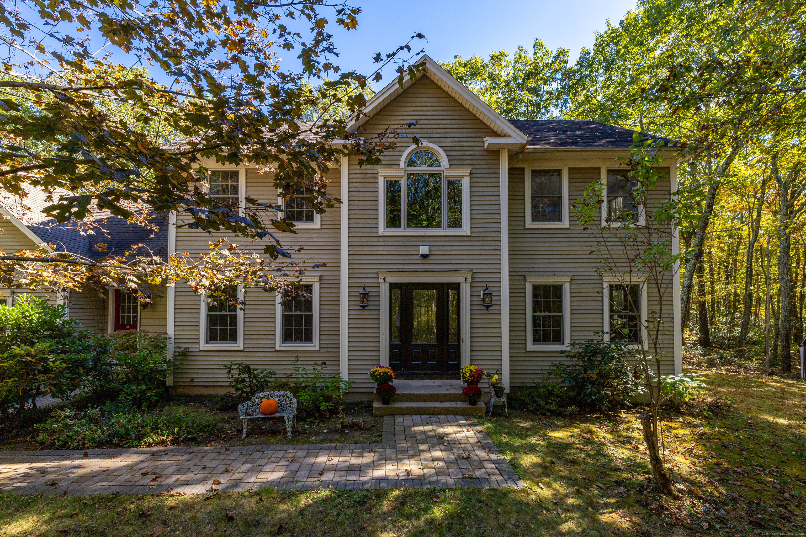 Escape to your own private sanctuary! This stunning four-bedroom Colonial sits majestically on approximately 12 acres along a quiet country road on Torrington's desirable west side. The heart of this well-appointed home is the chef's kitchen, featuring Wolf double ovens, Sub-Zero refrigerator, gas cooktop, oversized island with breakfast bar and elegant quartz countertops. Entertain effortlessly as the spacious family room flows seamlessly with rich hardwood floors, cozy wood-burning fireplace and French doors opening to the formal living room-currently showcased as a music room. Host memorable gatherings in the generous formal dining room, then retreat to the four-season sunroom complete with radiant heat and ceiling fan for year-round enjoyment. The main level is thoughtfully completed with a convenient laundry room, mud room, full bath and oversized two-car attached garage. Upstairs, the primary bedroom suite offers a peaceful retreat with walk-in closet and wall-to-wall carpeting. Three additional large bedrooms and a full bath provide ample space for family and guests. This tranquil country setting places you just minutes from both Torrington and Litchfield centers, offering easy access to fine dining, shopping, local theaters, award-winning wineries, golf courses and prestigious private schools.