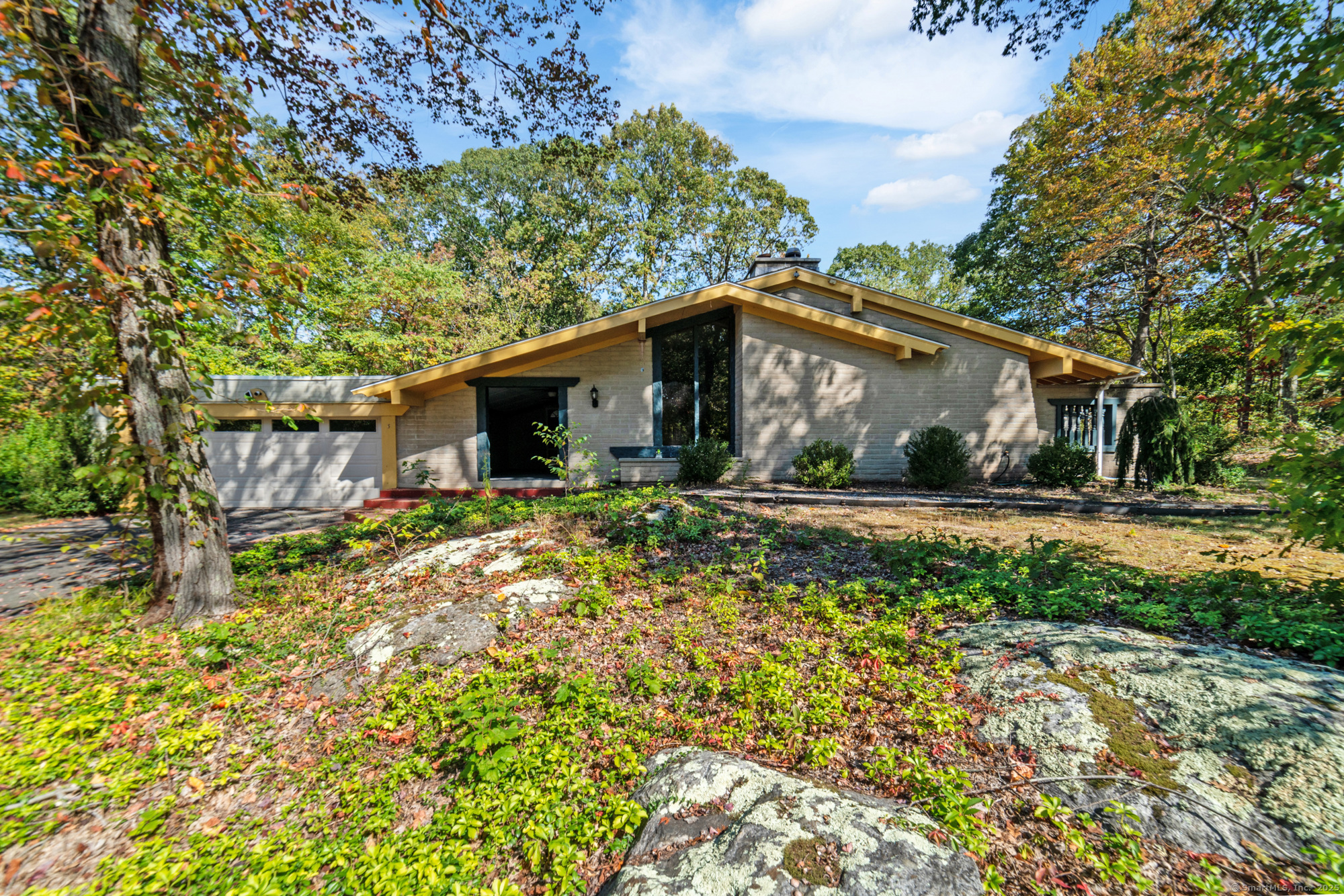 Step inside this striking contemporary ranch offering a layout unlike any other! Enter through the spacious enclosed covered patio that includes skylights, lighting, and ceiling fans- perfect for relaxing or entertaining. Inside, you'll find the formal living room featuring 9-foot ceilings, a gorgeous stone fireplace, and large windows that fill the space with natural light. Distinctive architectural details including exposed beams and cozy archways add even more warmth and character to this home's charming design. Just beyond the living room is a formal dining area that connects seamlessly to the kitchen's dining space creating an easy flow for everyday living and entertaining. The kitchen features stainless steel appliances and a generous, well-designed layout with an expansive dining area. This space offers plenty of room and functionality while still offering endless potential for modern updates and personal touches to suit your taste. Beyond the kitchen is a bright and spacious family room complete with skylights and a built-in wet bar, making it the perfect space for relaxing or hosting guests. Down the hall you'll find four bedrooms, including a primary suite with a private full bath with walk-in shower, & sliding doors leading to its own secluded patio. Outside, enjoy an additional patio area & an in-ground pool with two pool sheds. Updates include a newer roof, A/C, water heater, & upgraded forced hot air heat with backup electric baseboard heat. SOLD AS-IS.