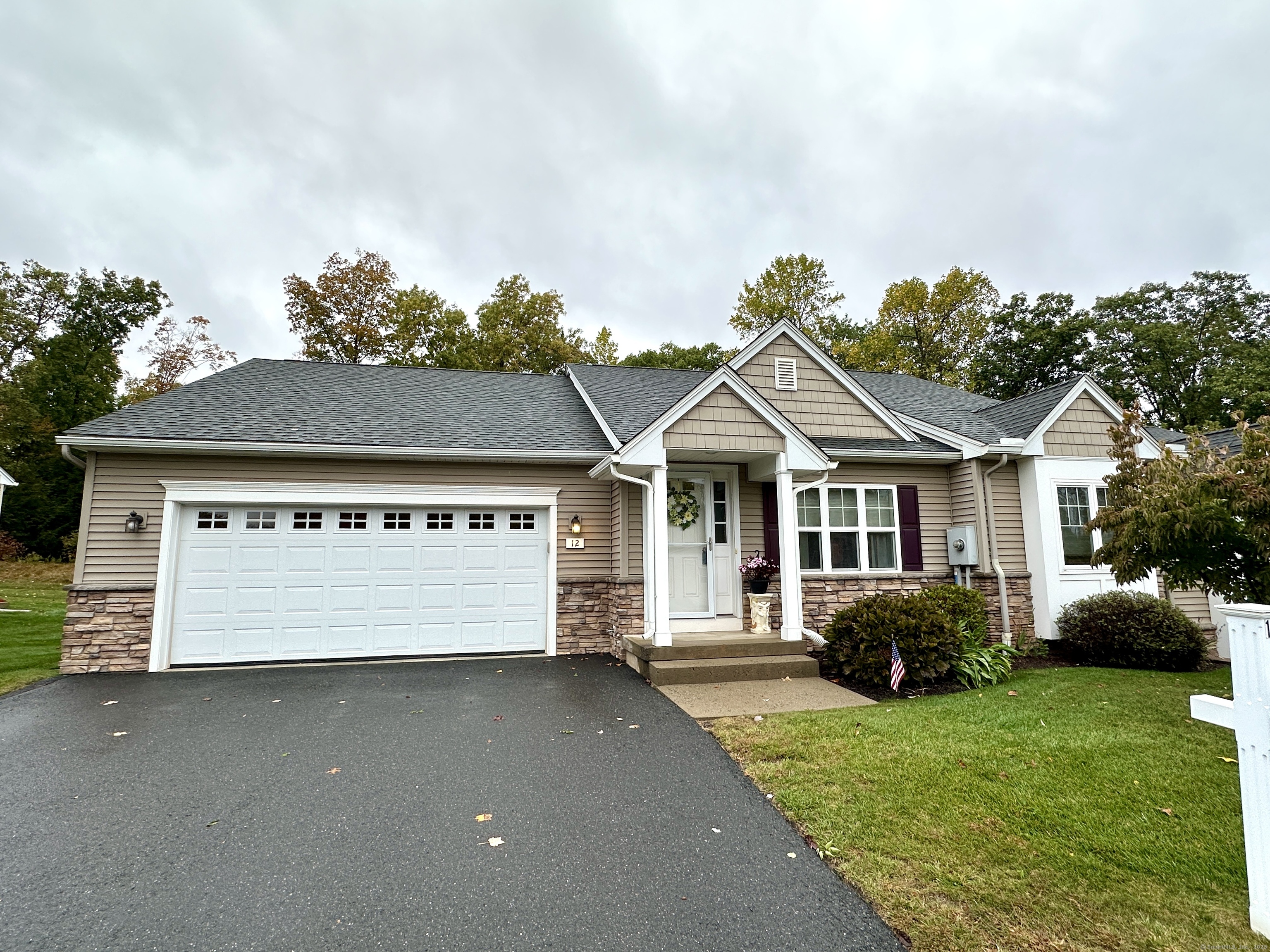 Welcome to Woodridge of Windsor Locks. This "Hampton" model ranch built in 2013 features an attached two-car garage and a comfortable layout for easy one-level living. The home includes a mudroom and laundry area conveniently located off the garage and kitchen. The open main living area has hardwood floors throughout the kitchen, dining, and living rooms. The kitchen offers custom cabinetry, a spacious dining area with sliders to the deck, and opens to the living room, making it a great space for everyday living or entertaining. The living room features a tray ceiling and a gas fireplace. The primary bedroom has double closets and a full en suite bath. A second full bath is also located on the main level. The full basement provides excellent potential for future finishing, with a half concrete wall and large windows across the back for natural light. Additional features include gas heat, central air, public water and sewer, and low HOA's of $270/month. Woodridge is NOT age restricted, 12 Woodridge offers a private backyard that backs to the protected Waterworks open space. Also listed as condo MLS#24133254