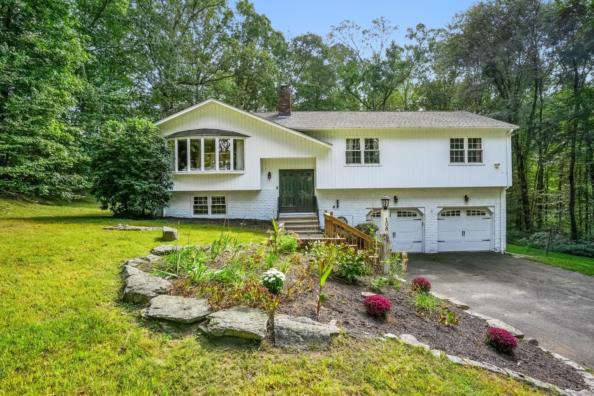 Welcome to 108 Wells Road, located in one of Monroe's most convenient neighborhoods. This beautifully updated home offers over 2,000 sqft of thoughtfully designed living space within the desirable Fawn Hollow district. Located just minutes from a private lake (Lakewood Estates)- for a small fee, enjoy beach access and year-round events-this home delivers a perfect blend of comfort, location & lifestyle. Inside, hardwood floors run through the main level, leading to 3 spacious bedrooms including a primary w/ a private bath. Enjoy central air, city water, and a brand-new hot water tank. The kitchen showcases ceiling-height white shaker cabinets with crown molding, stone countertops, stainless steel appliances & stylish tile backsplash. It opens seamlessly to the dining area, where quadruple-pane French glass doors lead out to a spacious deck-perfect for entertaining or relaxing. A stone patio and expansive gazebo complete the outdoor living space. The freshly painted exterior is enhanced by white brick accents, a six-pane bay window, and architectural roofline details that give the home standout curb appeal. The inviting living room is anchored by a classic fireplace, w/ a separate wall thoughtfully designed for your TV. Downstairs, the finished lower level adds versatility, featuring above-grade windows, newer flooring, and a second fireplace-ideal for a playroom, home office, family room. Move-in ready and ideally located, this home checks all the boxes. Welcome Home