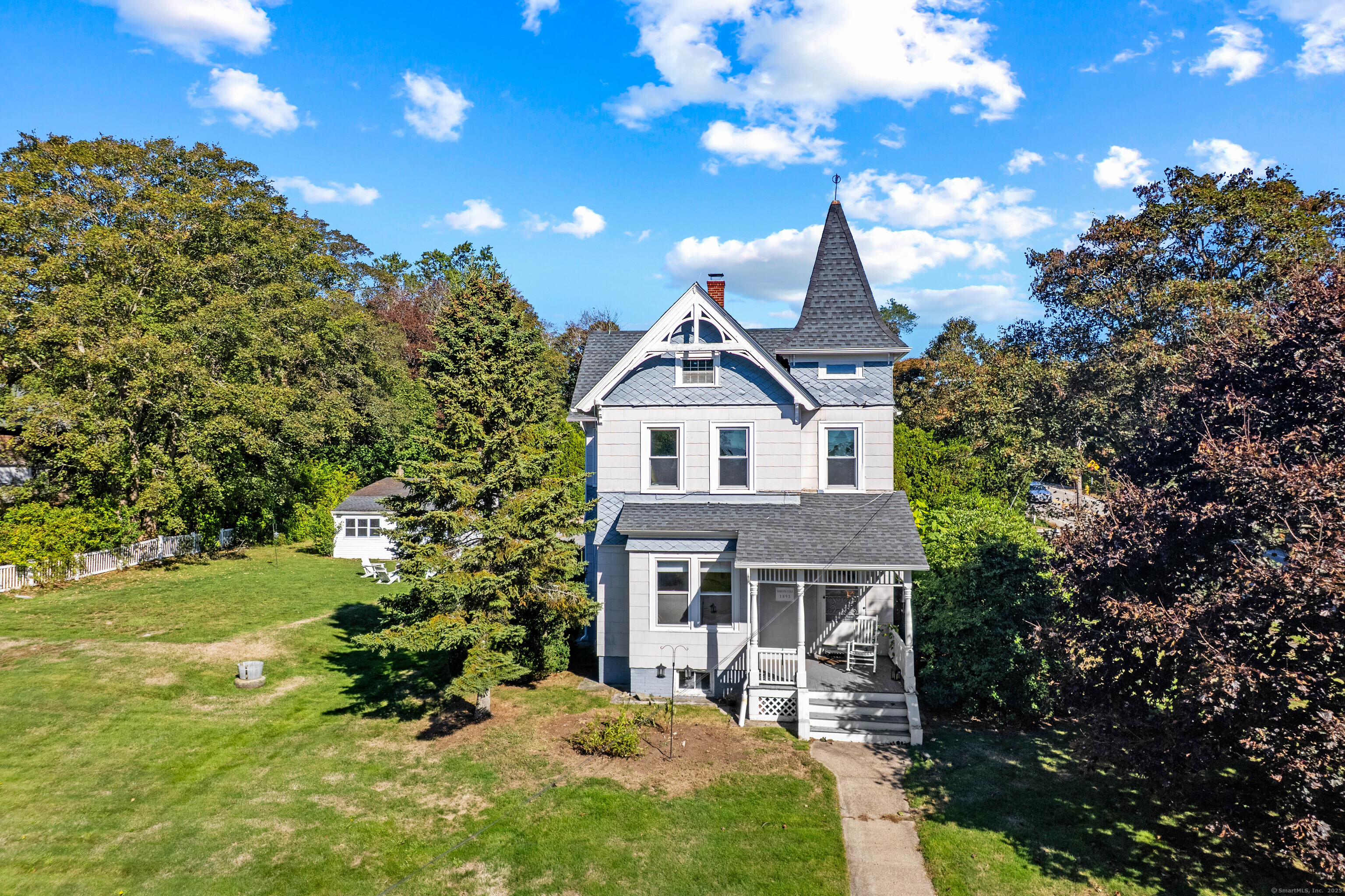 Charming Victorian home offers timeless appeal and spacious living on over half an acre of land. Located in the coastal seaside village of Noank, this home enjoys a serene New England setting known for its maritime heritage and scenic beauty. With 2,063 sf, this lovely home can serve as a 2-family duplex, with each unit offering 1 bedroom and 1 full bath. Beautiful hardwood flooring and solid wood doors add character and elegance throughout most of the home. Additional highlights include a full basement with potential for customization, and a detached 2-car garage and shed for additional storage. Residents are minutes from the local marinas, and the quaint shops and eateries of Noank Village. With nearby access to Esker Point Beach, Haley Farm State Park, and the vibrant attractions of downtown Mystic just a short drive away, this property offers the perfect blend of small-town tranquility and coastal New England lifestyle.