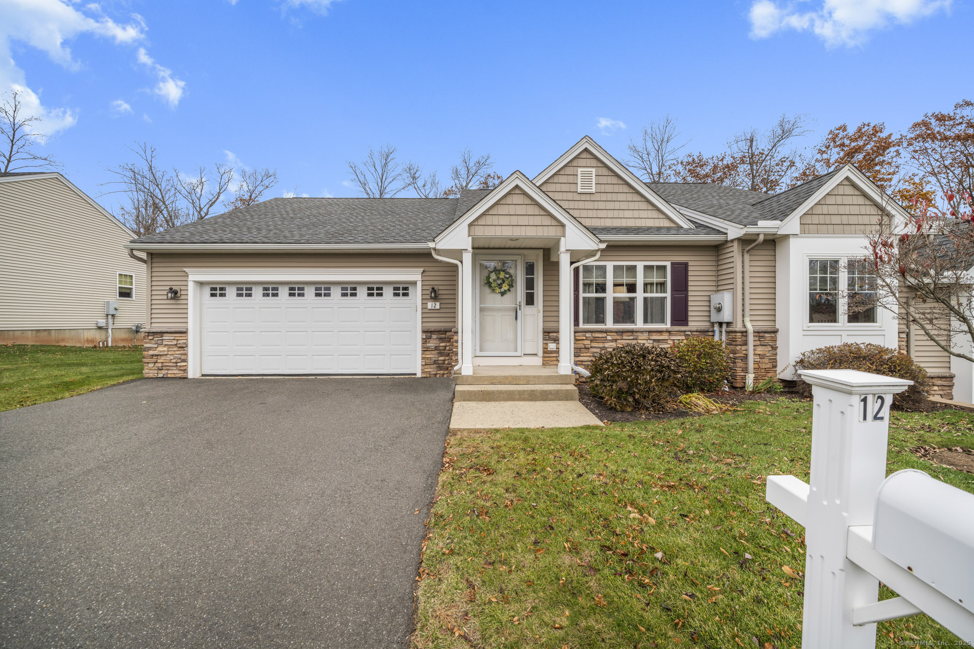 Welcome to Woodridge of Windsor Locks. This "Hampton" model ranch built in 2013 features an attached two-car garage and a comfortable layout for easy one-level living. The home includes a mudroom and laundry area conveniently located off the garage and kitchen. The open main living area has hardwood floors throughout the kitchen, dining, and living rooms. The kitchen offers custom cabinetry, a spacious dining area with sliders to the deck, and opens to the living room, making it a great space for everyday living or entertaining. The living room features a tray ceiling and a gas fireplace. The primary bedroom has double closets and a full en suite bath. A second full bath is also located on the main level. The full basement provides excellent potential for future finishing, with a half concrete wall and large windows across the back for natural light. Additional features include gas heat, central air, public water and sewer, and low HOA's of $270/month. Woodridge is NOT age restricted, 12 Woodridge offers a private backyard that backs to the protected Waterworks open space. Also listed as condo MLS#24133254