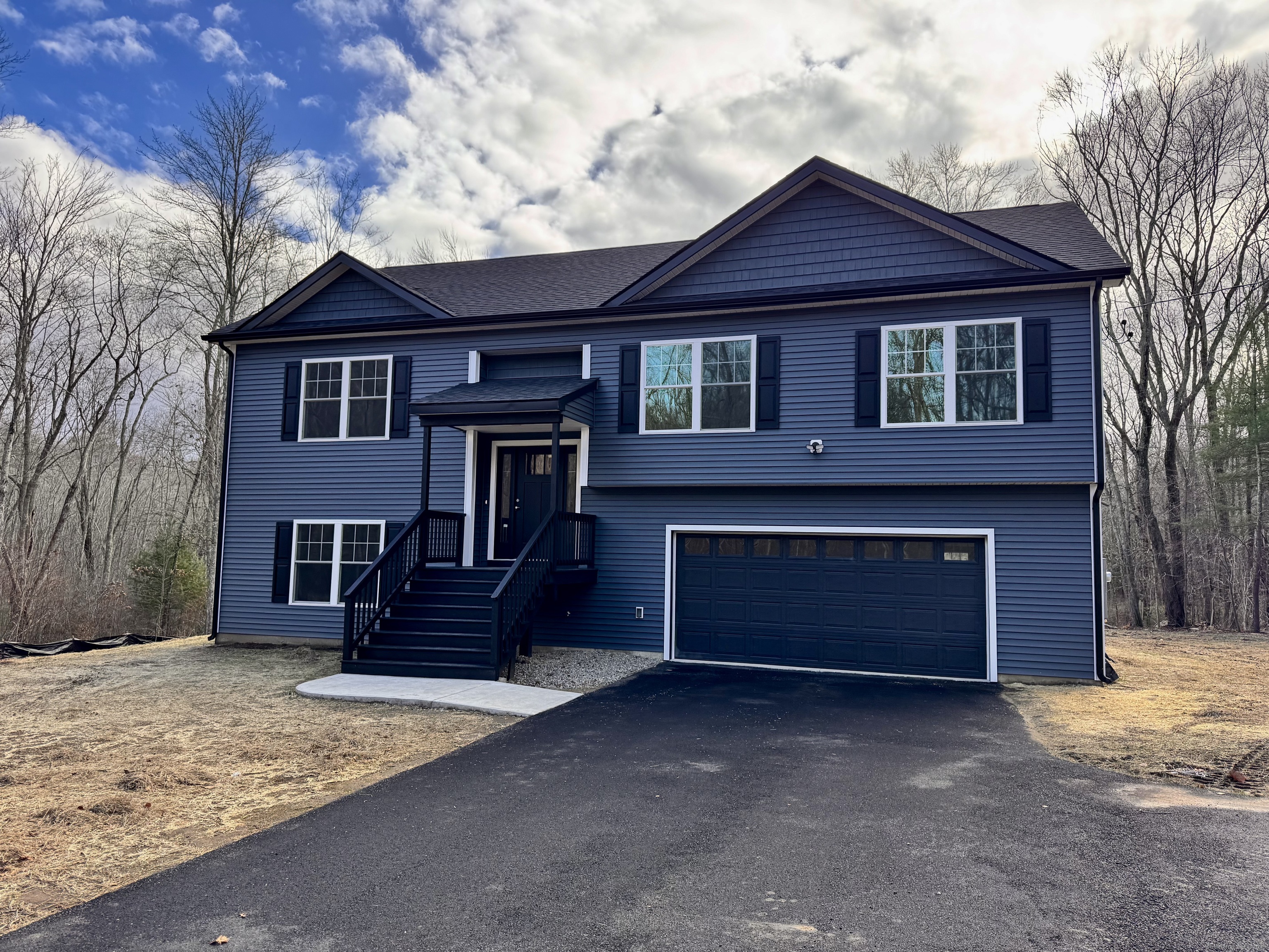 Peaceful country location. This 4 large bedroom 3 full bath home is setting out in a country location, but close to Rte. 6 for quick shopping. Amazing 2250 sq.ft. oversized raised ranch style home is welcoming & charming. The living room, dining area, and kitchen have vaulted ceilings and are all open to one another, perfect for entertaining. Breakfast bar in kitchen. granite counter tops and fully applianced. Very spacious Primary bedroom suite offers 2 closets, full bath with tri-lit mirror. 2 more large bedrooms & full bath on the main level. Lower level is sure to please you. Separate laundry area, another full bath and another huge bedroom. Could be used as a family room too. The garage is 24x30 2 cars will fit easily plus other large items. Every room has its own heat & AC Mitsubishi units. The sliders lead you onto a 10x16 rear deck with stairs to the rear yard. Generator hook-up too.