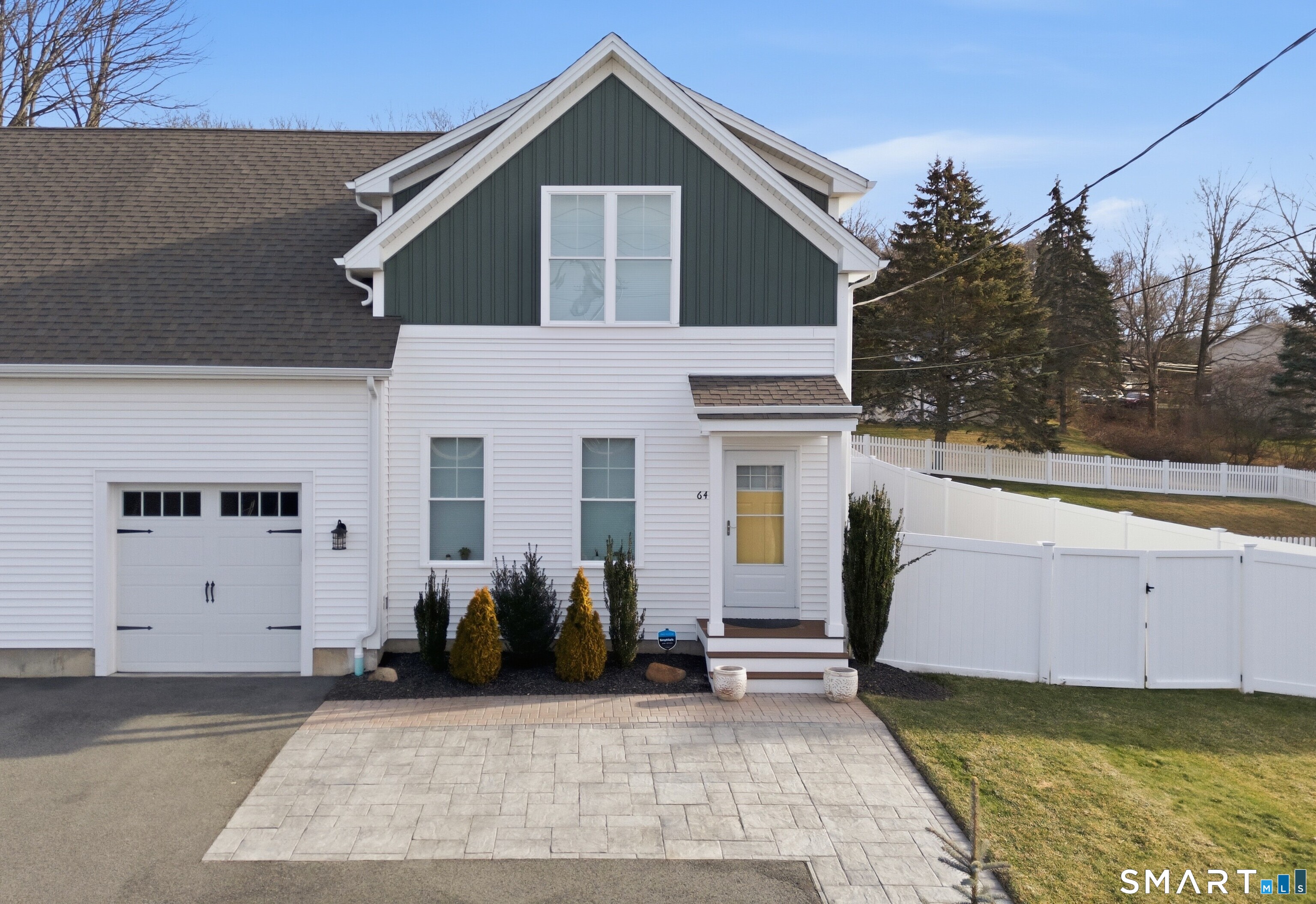 Exquisite showcase residence by an award-winning builder, where superior craftsmanship and refined design shine at every turn. This impeccably maintained home welcomes you with gleaming hardwood floors, soaring 9-foot ceilings, and elegant crown molding throughout the main level, creating an atmosphere of timeless sophistication. Designed for both everyday comfort and elevated entertaining, the open-concept floor plan flows seamlessly into a chef-inspired kitchen featuring granite countertops, stainless steel appliances, a generous breakfast bar, and a sunlit dining area. Glass sliders open to a private outdoor retreat with a stone paver patio-perfect for alfresco dining, entertaining guests, or unwinding in your own fenced-in oasis. Additional green space offers endless possibilities for a fire pit, garden, or play area. The main level is thoughtfully appointed with first-floor laundry and a stylish half bath, blending convenience with function. Upstairs, retreat to the oversized primary suite, complete with a spa-like private bath and ample closet space. A second bedroom and a versatile home office-ideal for remote work, a nursery, or guest bedroom-complete the second floor. The professionally finished lower level provides approximately 800 square feet of additional heated and air-conditioned living space, offering endless options for a media room, fitness studio, playroom, or elegant entertaining area, along with generous storage.