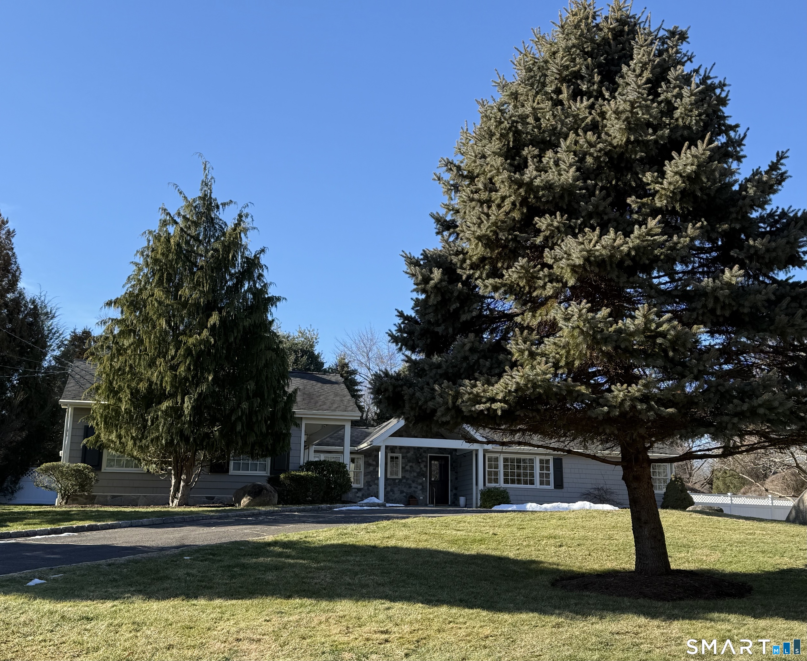 Welcome to this stunning Westover ranch, set on a sweeping driveway and filled with beautiful natural light. The open floor plan features a vaulted Great Room with fireplace, dining area, and granite kitchen with center island and six-burner dual-fuel range - all under soaring ceilings with skylights and cove lighting, and a wall of sliders overlooking the stone patio and gorgeous landscaped yard. The private primary suite offers a bedroom with fireplace, vaulted ceiling & 2 skyligths; updated full bath and walk-in closet. Two additional bedrooms are tucked off the main-level family room, along with a beautifully updated full bath. An office, powder room, workroom/shed, and direct access to the two-car garage complete the main level. The partially finished lower level provides flexible space with a playroom, office, and den, plus a large storage and mechanical room with washer and dryer. Outside, enjoy a lovely two-level fenced yard with bluestone patio, stone walls adorned with pollinator-friendly perennials and plenty of room for entertaining, play, or quiet relaxation. Located on a quiet cul-de-sac in desirable Westover with hardwood floors throughout the main level, city water and sewer, just minutes to the Merritt Parkway, schools, houses of worship, and a short drive to vibrant downtown Stamford and Harbor Point. A truly special home.