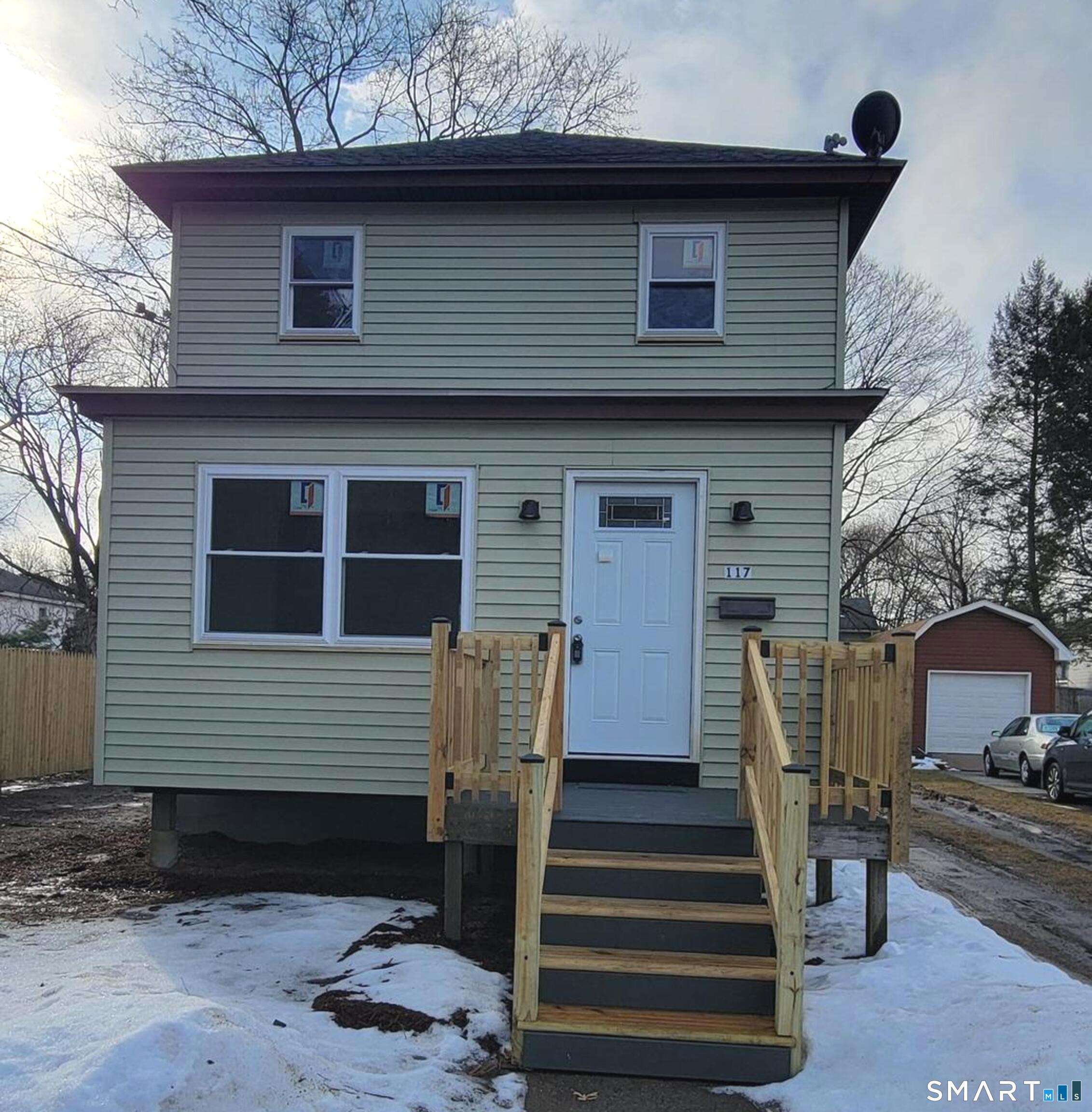 Newly remodeled and move-in ready home with an open-concept kitchen featuring a bar/counter, generous storage, and a half bath on the main level. Updates include a brand-new kitchen, new appliances, new windows, new flooring, and energy-efficient mini-split systems throughout. Infrastructure upgrades include a new 200-amp electrical panel, all new water lines, new water meter, and new shutoff valves. Roof replaced 11/23' per town, garage roof is new. The finished one-bay garage includes a loft, mini-split, rear storage door, and versatile space ideal for a home gym, studio, workshop, or office. Exterior features include off-street parking with gravel drive, fully fenced rear yard, and front and rear composite decks-rear deck measures 10x18, perfect for entertaining. Upstairs offers three bedrooms and a full bath. Interior finishes include porcelain tile, ceramic tile, luxury laminate flooring, and LED lighting throughout. All renovations completed with permits.