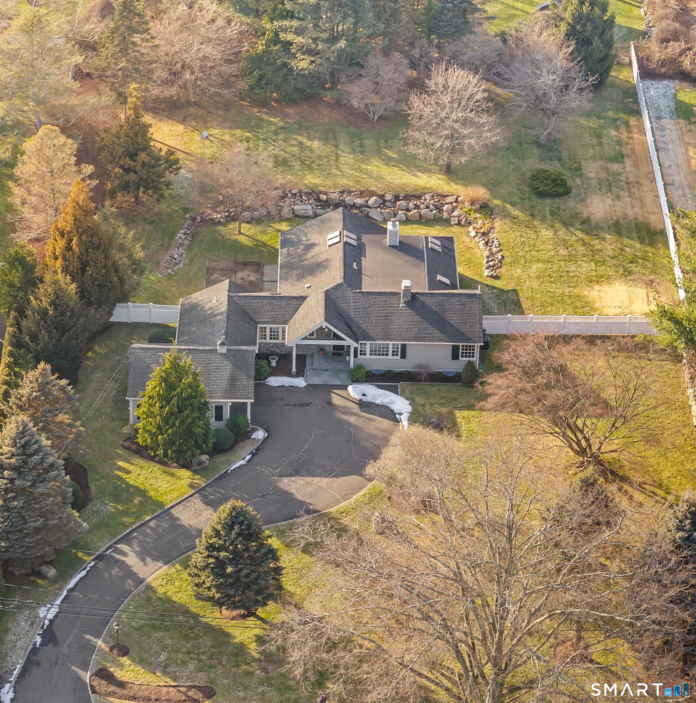 Welcome to this stunning Westover ranch, set on a sweeping driveway and filled with beautiful natural light. The open floor plan features a vaulted Great Room with fireplace, dining area, and granite kitchen with center island and six-burner dual-fuel range - all under soaring ceilings with skylights and cove lighting, and a wall of sliders overlooking the stone patio and gorgeous landscaped yard. The private primary suite offers a bedroom with fireplace, vaulted ceiling & 2 skyligths; updated full bath and walk-in closet. Two additional bedrooms are tucked off the main-level family room, along with a beautifully updated full bath. An office, powder room, workroom/shed, and direct access to the two-car garage complete the main level. The partially finished lower level provides flexible space with a playroom, office, and den, plus a large storage and mechanical room with washer and dryer. Outside, enjoy a lovely two-level fenced yard with bluestone patio, stone walls adorned with pollinator-friendly perennials and plenty of room for entertaining, play, or quiet relaxation. Located on a quiet cul-de-sac in desirable Westover with hardwood floors on the main level, city water and sewer, just minutes to the Merritt Parkway, schools, houses of worship, and a short drive to vibrant downtown Stamford and Harbor Point. A truly special home.