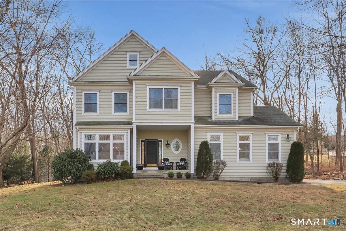 Welcome to a truly happy home that is classic, stylish, and anything but cookie cutter. From the moment you step inside, you are greeted by an impressive open and airy layout enhanced by beautiful mouldings throughout that add character, depth, and architectural interest. The living room features a stunning coffered ceiling that sets the tone for the sophistication found throughout the home. The first floor is exceptional, offering beautiful sight lines as the living room flows seamlessly into the formal dining room, creating a perfect setting for both everyday living and entertaining.The kitchen is well appointed with abundant cabinet space, a center island, and a comfortable eating area with direct access to the deck. Just beyond, the family room is truly impressive, highlighted by soaring two story windows, a fireplace that adds warmth and ambiance, and a vaulted ceiling that elevates the entire space.The upper level offers four bedrooms, including a spacious primary suite with a walk in closet and an updated full bathroom featuring a whirlpool tub. The expansive unfinished basement provides ample storage and endless possibilities for future use. Set on nearly an acre of land, this home enjoys a sunny and private setting. Bright, welcoming, and architecturally sophisticated, this is a very special place to call home!