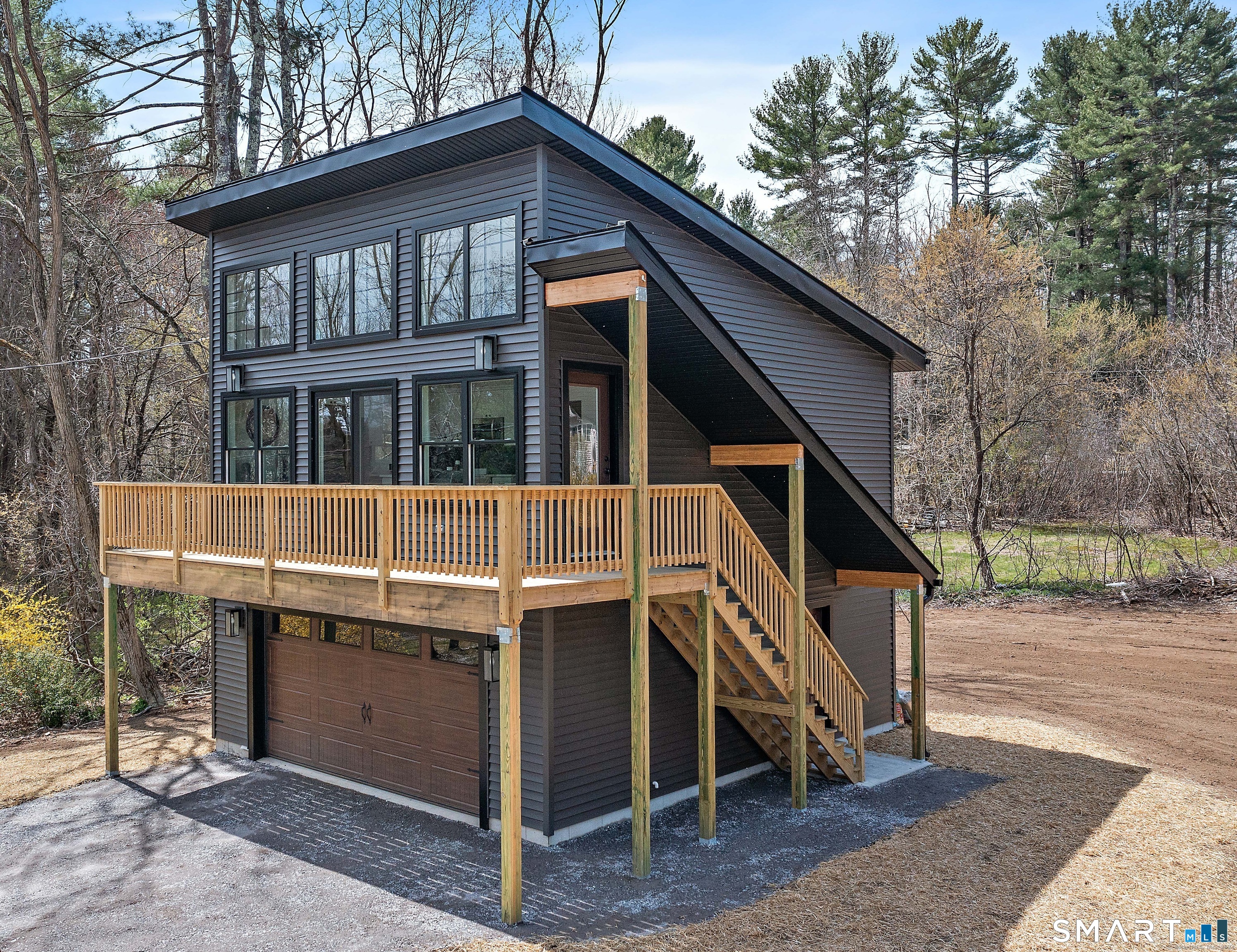 Stunning 2-year-old contemporary offering an open, sun-filled floor plan designed for modern living. Oversized windows throughout capture beautiful views of Lake Quaddick, filling the home with natural light and a seamless connection to the outdoors.  The gorgeous kitchen features crisp white cabinetry, granite countertops, a center island, and comes fully applianced, making it perfect for both everyday living and entertaining. The open layout flows effortlessly into the living and dining areas, all highlighted by clean lines and a bright, airy feel.  Additional features include air conditioning, a spacious deck ideal for relaxing or hosting while enjoying the lake views, and a two-car garage located underneath for convenience and storage. A rare opportunity to own a nearly new home with contemporary style and scenic surroundings.