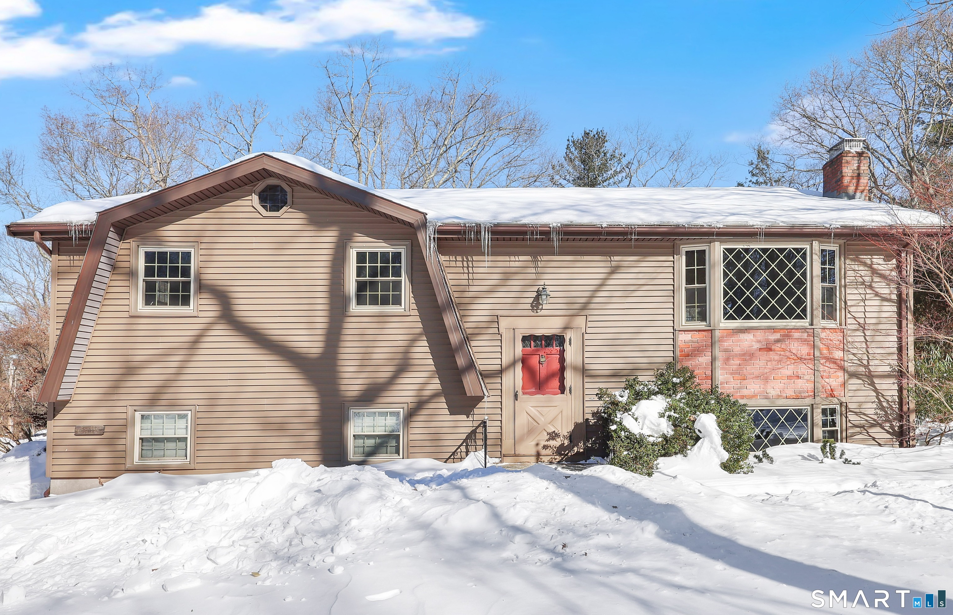 A true gem in a highly desirable neighborhood in Tolland! All the major system upgrades have been taken care of - new roof, new boiler, new septic, newer windows and siding, updated electrical, plus a generator hookup with generator included for peace of mind. Inside, you'll find a spacious layout featuring vaulted ceilings, exposed beams, and a cozy fireplace that adds warmth and character. Potential hardwood under the carpeting. The full bathroom has been beautifully updated with a walk-in shower, new vanity, countertop, and modern light fixtures.The primary bedroom offers hardwood flooring, a large closet, and its own half bath. The primary bathroom includes an oversized closet with potential to convert into a laundry area or expand into a shower or tub - adding even more value and flexibility. The lower level features an additional room complete with a custom built-in cubby - perfect for a guest space, home office, or playroom. Step outside to an updated deck overlooking a private backyard escape, ideal for bird watching, unwinding, and soaking in the tranquility of nature. The well-designed shed with dual compartments, provides convenient storage for all your lawn tools and essentials. Bring your decorating ideas and transform this well-maintained home into a true showstopper. An incredible opportunity in a special neighborhood!