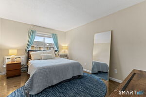 Bright second bedroom with hardwood floors and generous closet space - perfect for guests, family, or a home office.