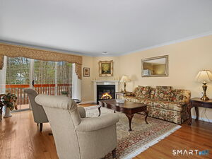 Living Room with beautiful hardwood floors, gas fireplace and sliders to deck