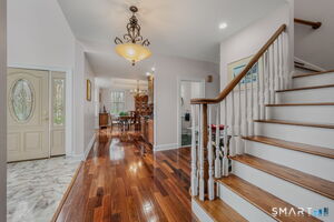 Foyer with formal staircase and Dining Room.