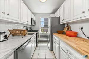 Updated galley kitchen with stainless steel appliances