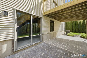 Back Side of home by walkout to concrete patio