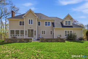 This custom built home was designed to capture the beauty of the back yard. Large windows in every room look out at the brook where it is common to see deer drinking from the brook and running through the woods.