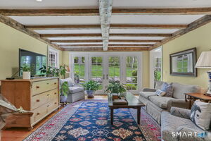 Cozy den off of kitchen with French doors out to the yard