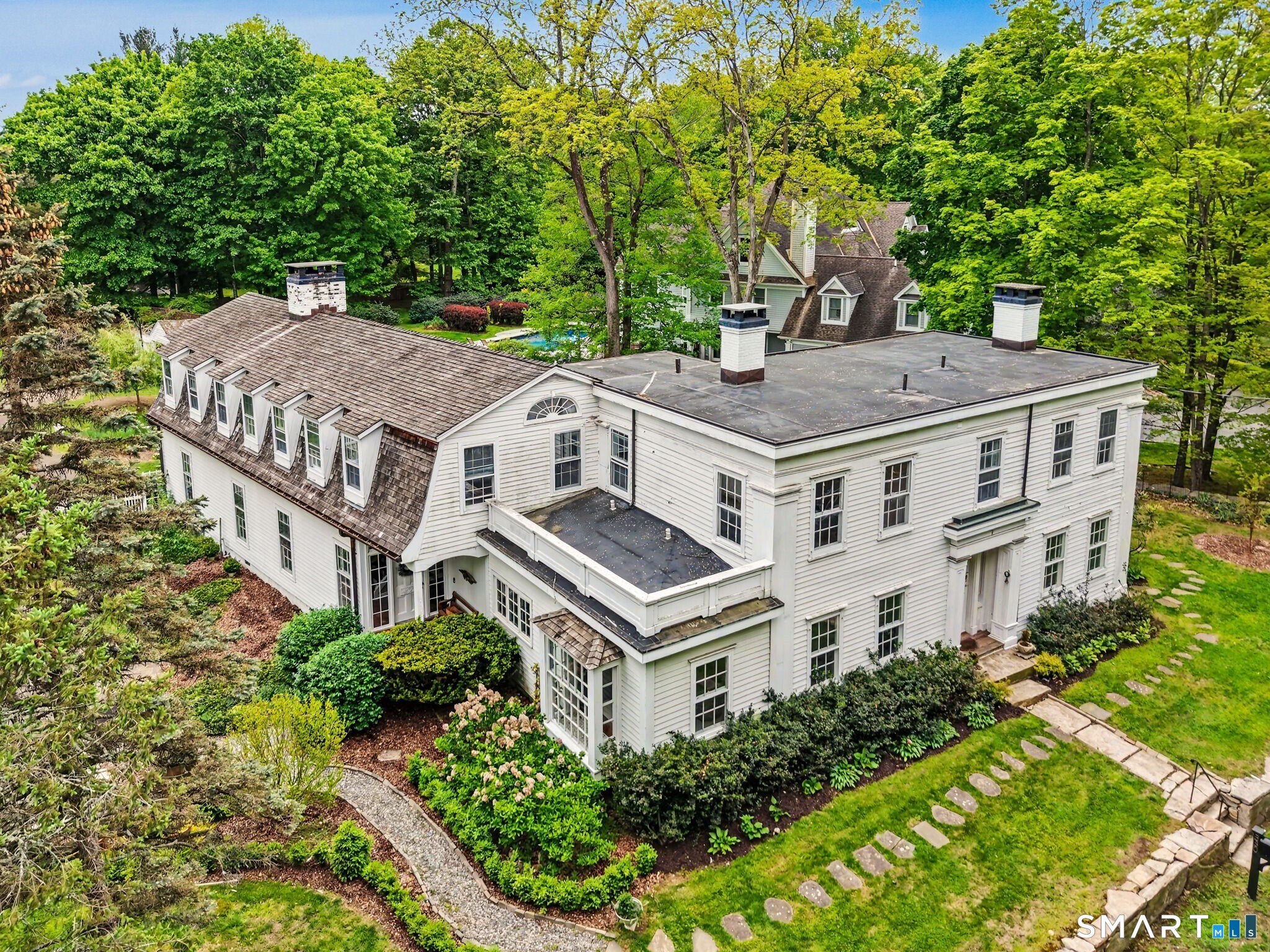 Offering a warm blend of 19th-cent character & modern updts, this 1860 Greek Revival Col showcases truly distinctive features. Despite its expansive 5,358sf, the home feels inviting & intimate, highlighted by rustic design elements incl brick hallways & accents. Orig rich random width pumpkin pine plank flrs recently refin 10' clgs thru-out & 5FPs. Set on 1.22 lvl acres w/specimen trees, this special property offers a peaceful, prvt setting in desirable Westover-just moments from city amenities. The orig residence, believed to be the orig area farmhse, feat a gracious LR & DR both w/FPs, Kit w/access to charming Bkfst Rm, Full Bth & unique brick hallway w/sunlit nooks ideal for reading, gardening & relaxing. An award-winning late 1960s addition recognized for architectural accuracy of design & craftsmnshp, enhances the home w/stunning FR feat a wall of blt-ins & spacious Den-both w/FPs & wonderful windows flooding the space w/natural light. Upstairs you'll find a priv & spacious PBR w/FP & en-suite Full Bth. 4 add'l BRs, 3rd Full Bth w/Laundry, & a framed space ready for an add'l bth, +a bright, airy Bonus Rm. Dramatic walls of floor-to-clg windows overlook the brick patio & beautifully landscaped grounds. The lvl, fenced yard w/mature plantings provides a serene outdoor retreat perfect for relaxation and entertaining. This wonderful home features brand new mech sys incl C/A, Furnace, Wtr Htr, Boiler & Well Purification sys.