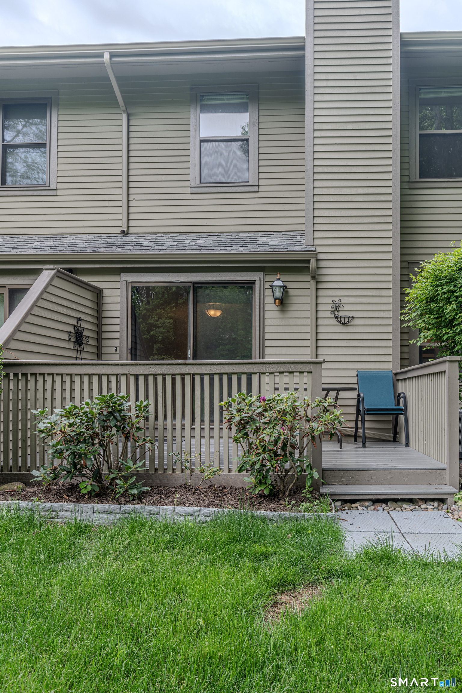 Experience elevated townhouse living in the highly sought-after Winding Brook community. Tucked away in a peaceful corner of the complex near the tennis courts and community garden, this exquisitely updated 2-bedroom, 1.5-bath residence blends sophisticated design with effortless comfort. Thoughtfully renovated, the home showcases an impressive array of upgrades including fresh designer paint, new carpeting and flooring, custom cabinetry, sleek stainless steel appliances featuring a smart stove, updated lighting, modern sinks and fixtures, new toilets, and a new hot water heater-every detail carefully curated for today's discerning buyer.  The distinctive multi-level floor plan offers both architectural interest and exceptional flow. Enter through the welcoming ground-level foyer and ascend to a dramatic living room highlighted by soaring ceilings, a cozy wood-burning fireplace, and sliding glass doors opening to a private deck surrounded by tranquil natural views. Just above, the elegant dining area provides the perfect setting for entertaining, while the beautifully remodeled kitchen combines style and functionality with ease. Upstairs, retreat to a spacious primary bedroom along with a generously sized second bedroom and an updated full bath. The partially finished lower level offers versatile additional living space, complete with washer and dryer access.Additional features include a one-car attached garage, efficient gas heating, and central air.