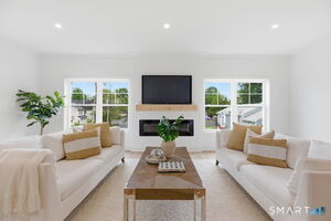 Spacious family room with hardwood floors, 9ft. ceilings and fireplace.