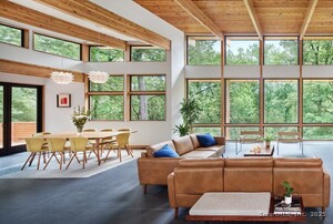 A second view of the great room in the Usonia Historical District house, showing the transition to a 12-foot ceiling height to accentuate the dining area.