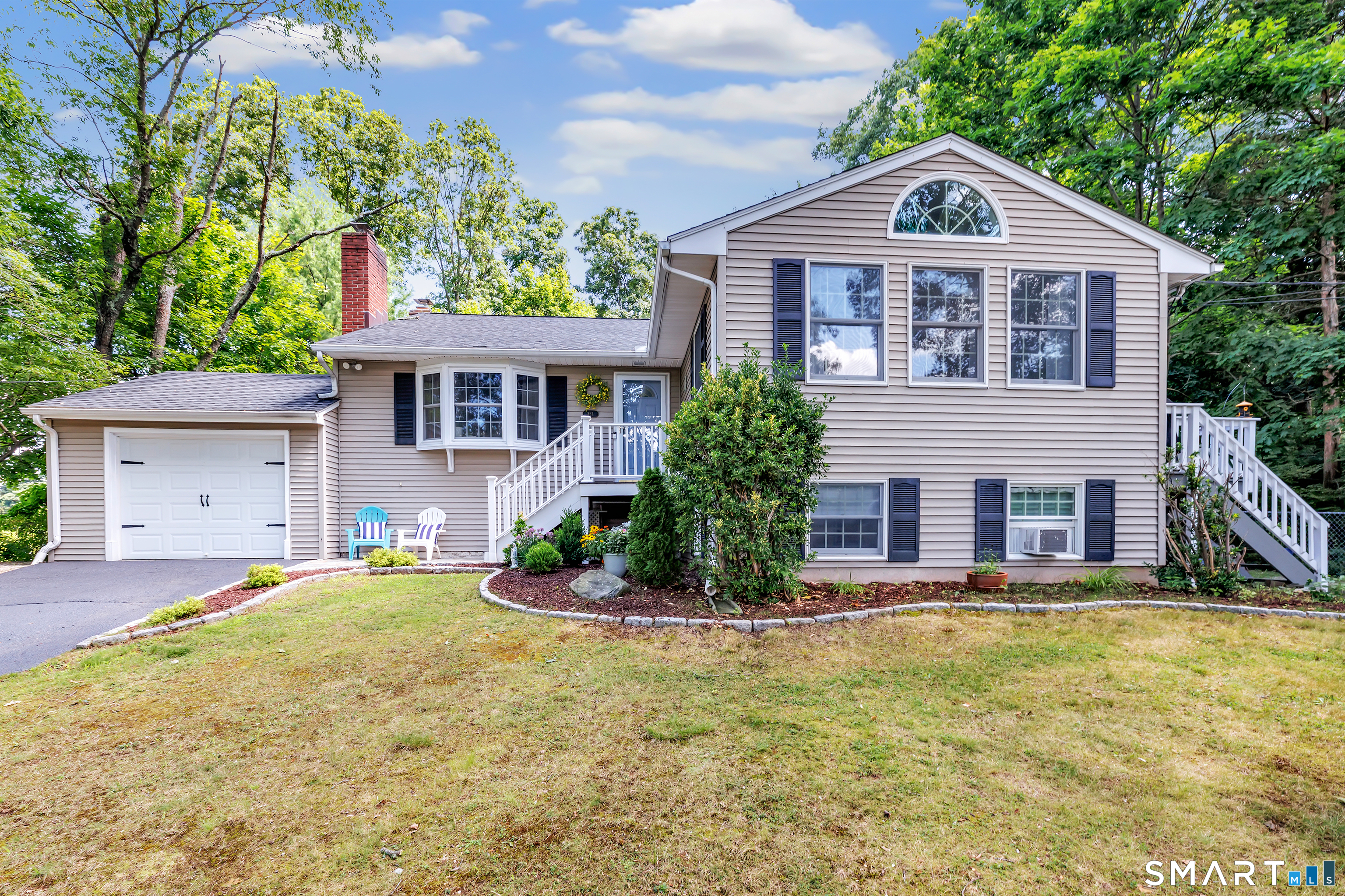 Spacious split-level home offering approximately 2,200 square feet of living space on a .25-acre lot. The main level features a living room with vaulted ceiling, hardwood floors and fireplace, along with an eat-in kitchen offering a breakfast bar, vaulted ceiling and skylight. The upper level includes the primary bedroom and two additional bedrooms. A lower-level family room with a second fireplace provides additional living space. The finished basement offers a potential fourth bedroom, full bath and flexible space that may be suitable for a potential in-law setup, guest area, home office or recreation room. Additional highlights include a newer roof, new furnace, central air, storage shed, garden area and apple trees.
