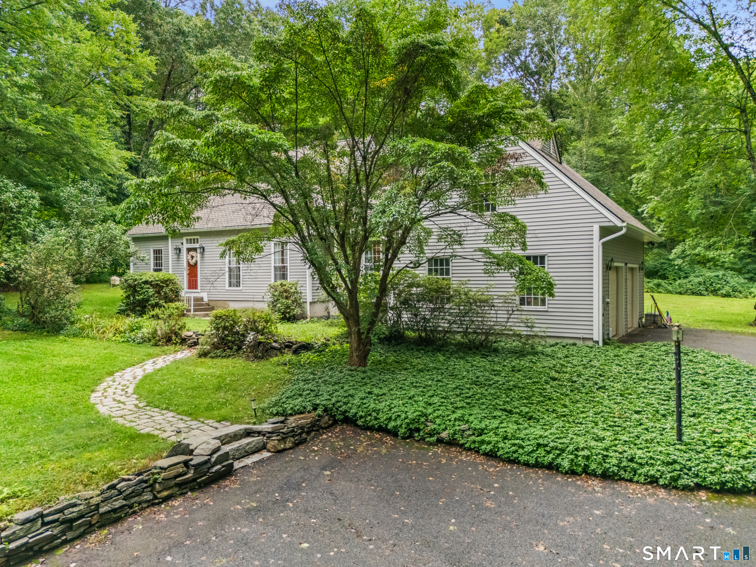 Tucked away in the midst of mature trees, on a beautiful 1.69-acre setting, this spacious cape offers an exceptional amount of gathering spaces. The heart of the home is a 30' kitchen that features a see-through fireplace (to the living room), breakfast area with sliders to an expansive deck, breakfast bar, pantry, and French doors to a large family room with pellet stove. From there, enter an office, four-season sunroom, or half bath. Also near the kitchen are a formal dining room & living room. The laundry room is between the kitchen and 2-car garage, which has a second floor-perfect for storage or potential bonus room. The unfinished basement has many possibilities as well. Upstairs, the primary bedroom features a sitting area, full bath with double vanity and walk-in closet. A second full bath serves 2 more bedrooms, one of which is 20'+ long and can easily accommodate 2 queen-size beds (like 2 bedrooms in 1!) The private backyard is perfectly designed for both relaxation and active outdoor living, offering both natural beauty and functional space: a large deck for entertaining or relaxing, a sparkling pool with a new liner, and a wide, flat lawn for sports activities. The long driveway and parking area in front easily hold several vehicles. Other highlights include: newer roof, windows, kitchen counters, oil tank; freshly painted exterior; de-popcorned ceilings; generator and hookup; recapped chimney; new well cap and more! Private, yet easy access to Rt 2 for commuting.