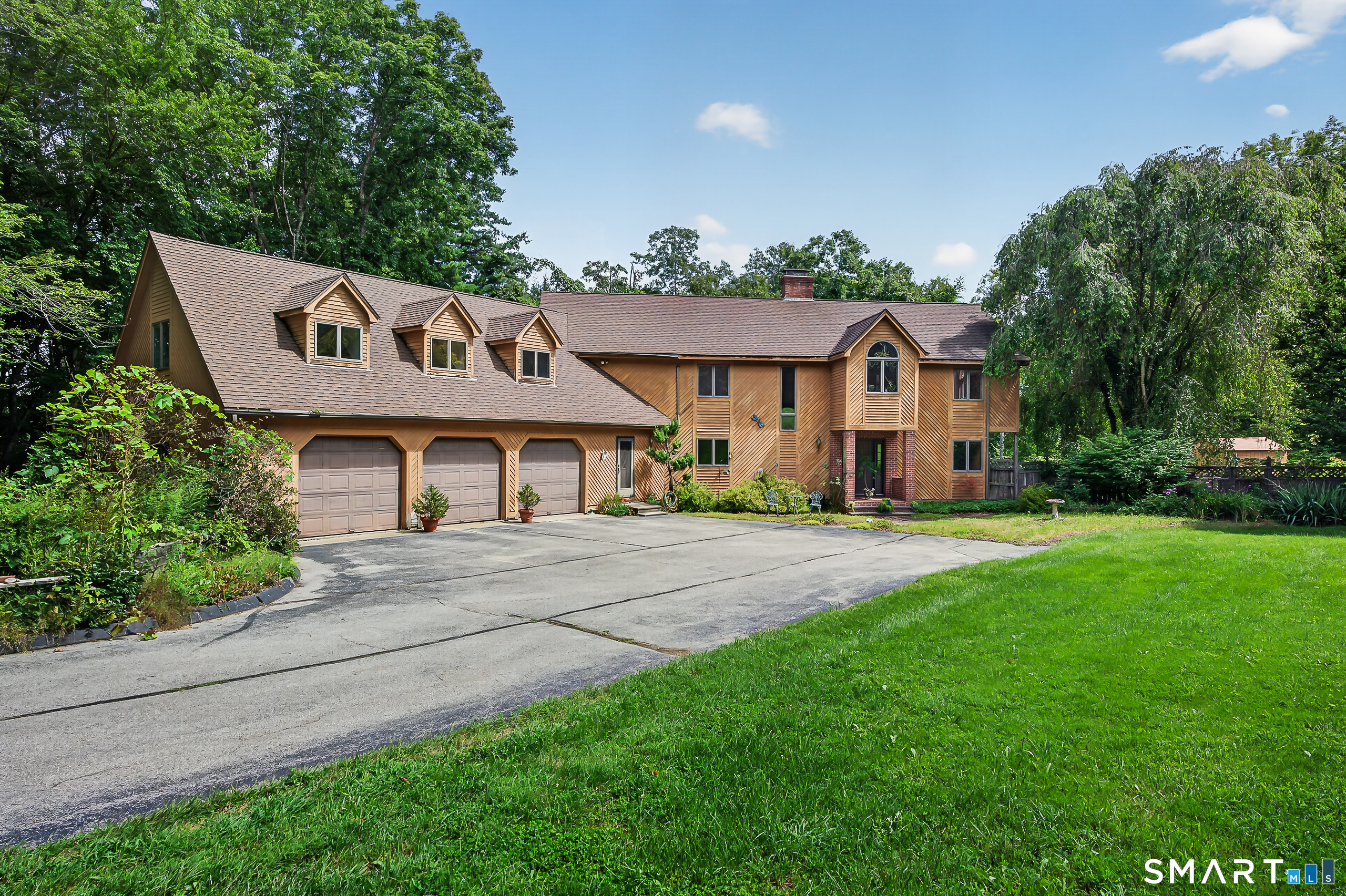 Set on nearly 25 private acres in Pomfret, this well maintained and upgraded 3,343 sq ft home offers space, privacy and incredible recreational potential. Features include a 3-car attached garage with an attached workspace, primary suite w/private balcony & jetted tub, central air, ducted heat, a whole-house generator and a heated/cooled basement offering an easy path to additional finished space and extra bedroom potential. Inside, enjoy a beautiful stone fireplace with wood-stove insert, while a screened porch off the dining room overlooks a wooded setting. Extensive covered deck space provides even more outdoor living, including the current hot tub, which is included. A detached, fully insulated and heated garage/workshop with a full 16' door provides exceptional space for vehicles, equipment, hobbies or storage. Established riding and walking trails wind throughout the acreage. The property also features a former in-ground pool with potential for restoration and a former ice rink/tennis/pickleball court ready to be brought back to life. An ideal setting for a private retreat or a horse farm, with abundant space for recreation, equipment, toys and outdoor living. Ideal for anyone seeking a serious workshop, trail riding, outdoor entertaining and room to spread out. A rare combination of acreage, recreation, storage, privacy and flexible space. Conveniently located under 30 miles from Providence, 34 miles from Foxwoods and Mohegan Sun with easy access to I-395.