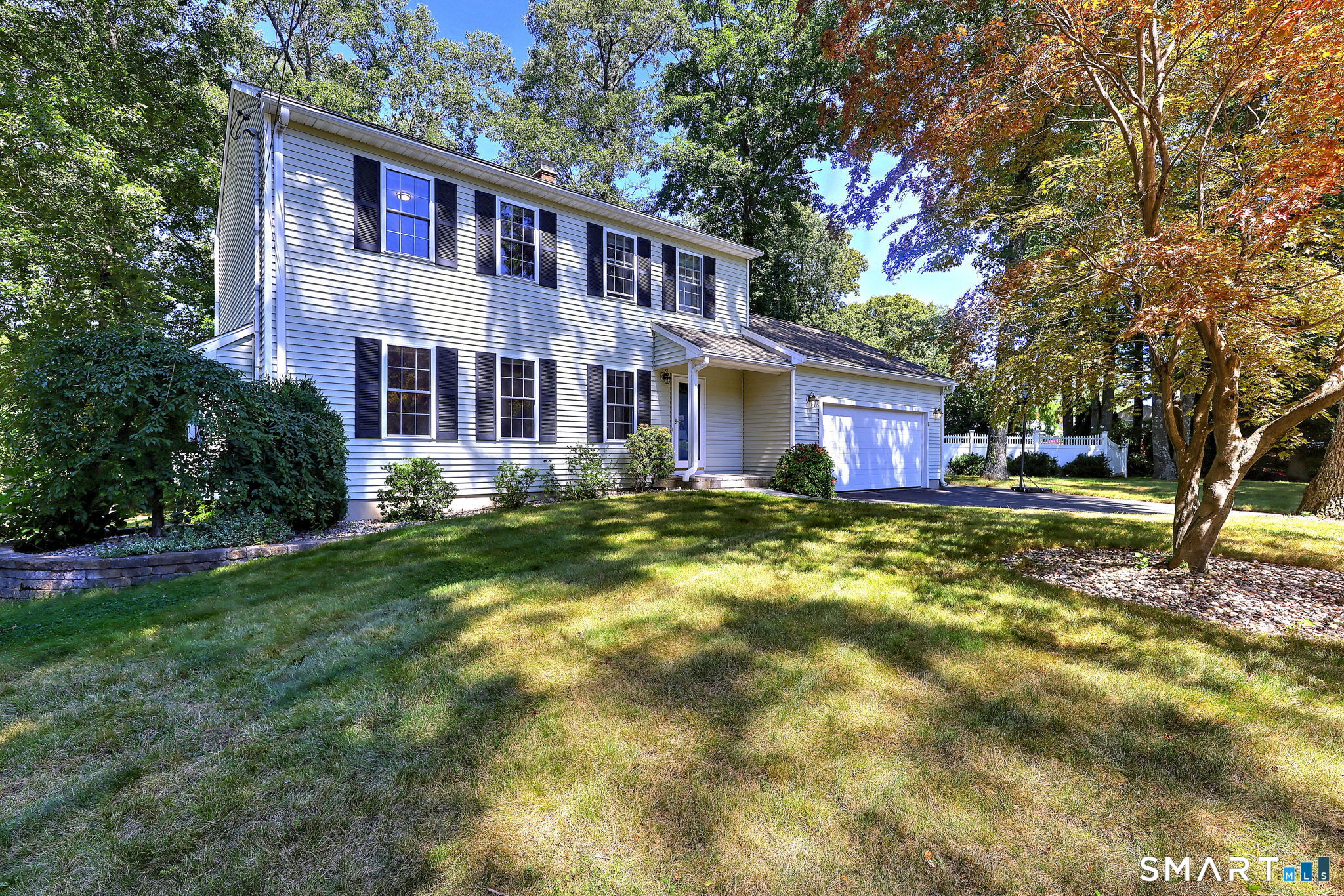 Welcome to this beautifully maintained Colonial in Farmington's desirable Unionville neighborhood! Offering a wonderful blend of comfort and inviting outdoor spaces, this move-in-ready home is designed for both everyday living and entertaining. Step inside to a bright and welcoming living room featuring a cozy gas fireplace, flowing naturally into the formal dining room. Large windows bring the beauty of the private, nearly half-acre wooded lot into view. The updated eat-in kitchen is both functional and stylish, featuring granite countertops and stainless-steel appliances. Just beyond the kitchen, a peaceful sunroom provides an ideal spot to enjoy the seasons, with expansive windows, a beautiful wood ceiling, and direct access to the freshly painted deck. Upstairs, the spacious primary suite offers a walk-in closet and a beautifully renovated private bath. Two additional bedrooms provide comfortable accommodations. The lower level offers valuable additional space and an opportunity to create a recreation room, home office, gym, or whatever best suits your needs. With professionally landscaped grounds, the backyard offers an inviting space for relaxation and entertaining. Don't miss the opportunity to see this beautiful home, schedule your showing today!