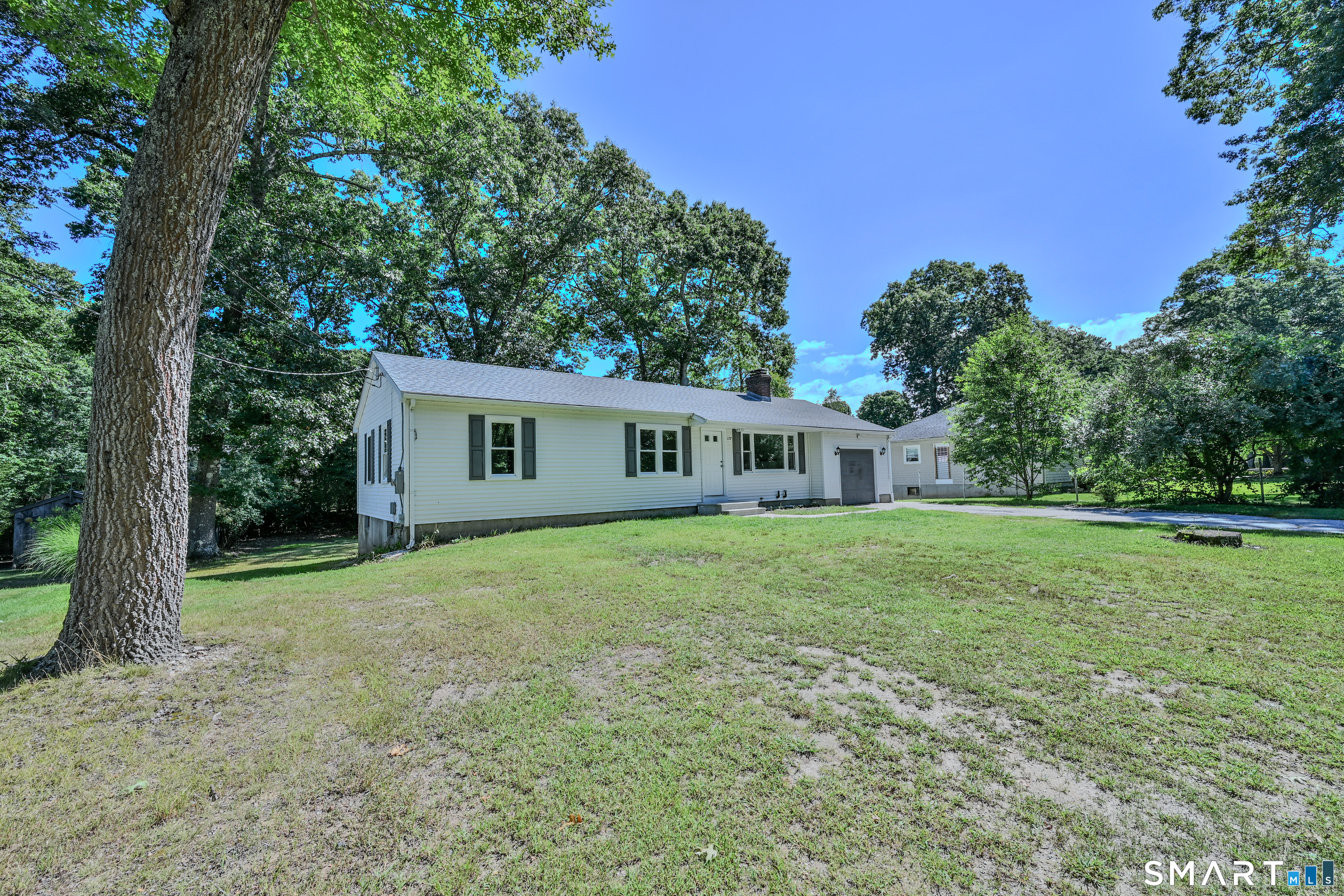 Nearly 1,700 SF ranch offering a hard-to-find 1-bedroom in-law setup, all conveniently located on the first floor! The in-law space features its own full kitchen/living area, full bath with laundry, bedroom & separate entrance, providing excellent options for extended household needs. The main living area offers a spacious layout with an updated kitchen featuring granite counters, refreshed bath & fresh paint! Numerous updates include the roof, electrical service & more, making this home truly turnkey. Step outside to an enormous rear deck overlooking the flat backyard, perfect for relaxing or entertaining. The lower level offers substantial additional space & excellent potential for future finishing. Ideally located just minutes from highway access, approximately 20 minutes to Worcester & about an hour to Boston, Providence, Hartford & Springfield. A versatile, updated home in an exceptionally convenient commuter location!