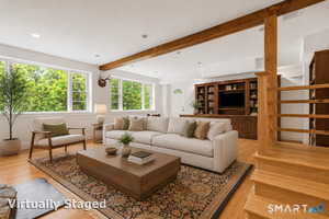 Lower level family room with door leading to side yard. Perfect space for in-laws, play room, etc.