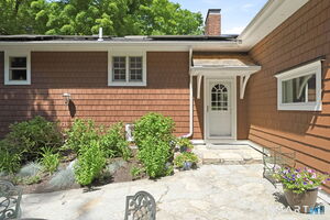 This is the main entrance they use off of a magnificent stone patio and surrounded but perennial beds blooming throughout the growing season.