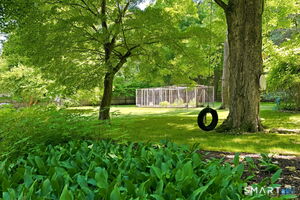 Backyard vegetable garden and large shed. Behind garden is your own private path adjacent to Topstone Park.